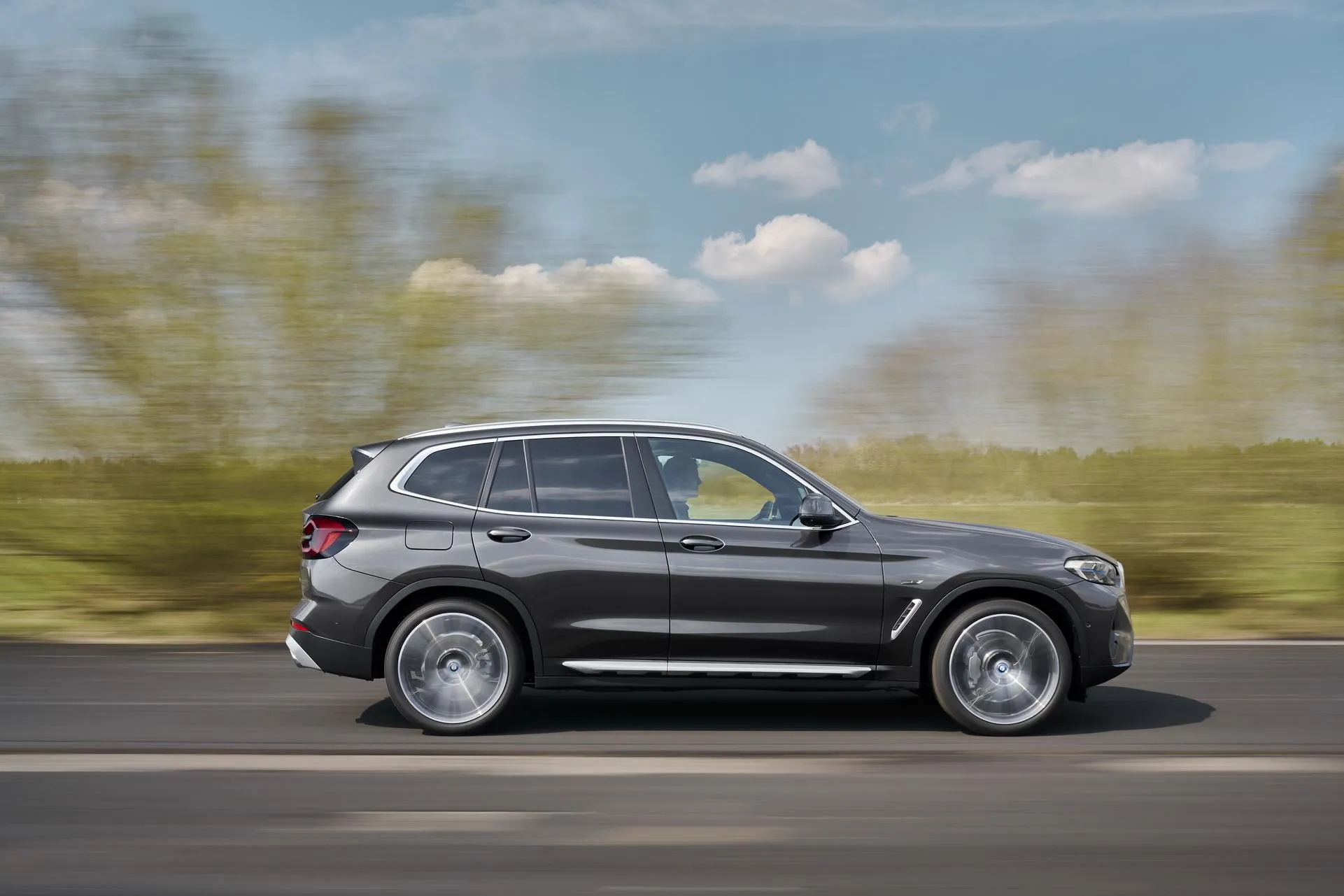 Bmw X5 Driving on a Countryside Road with Blurred Trees