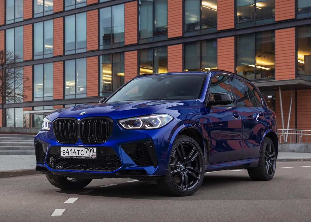 Bmw X5 Driving on a Road with Scenic Landscape in Background