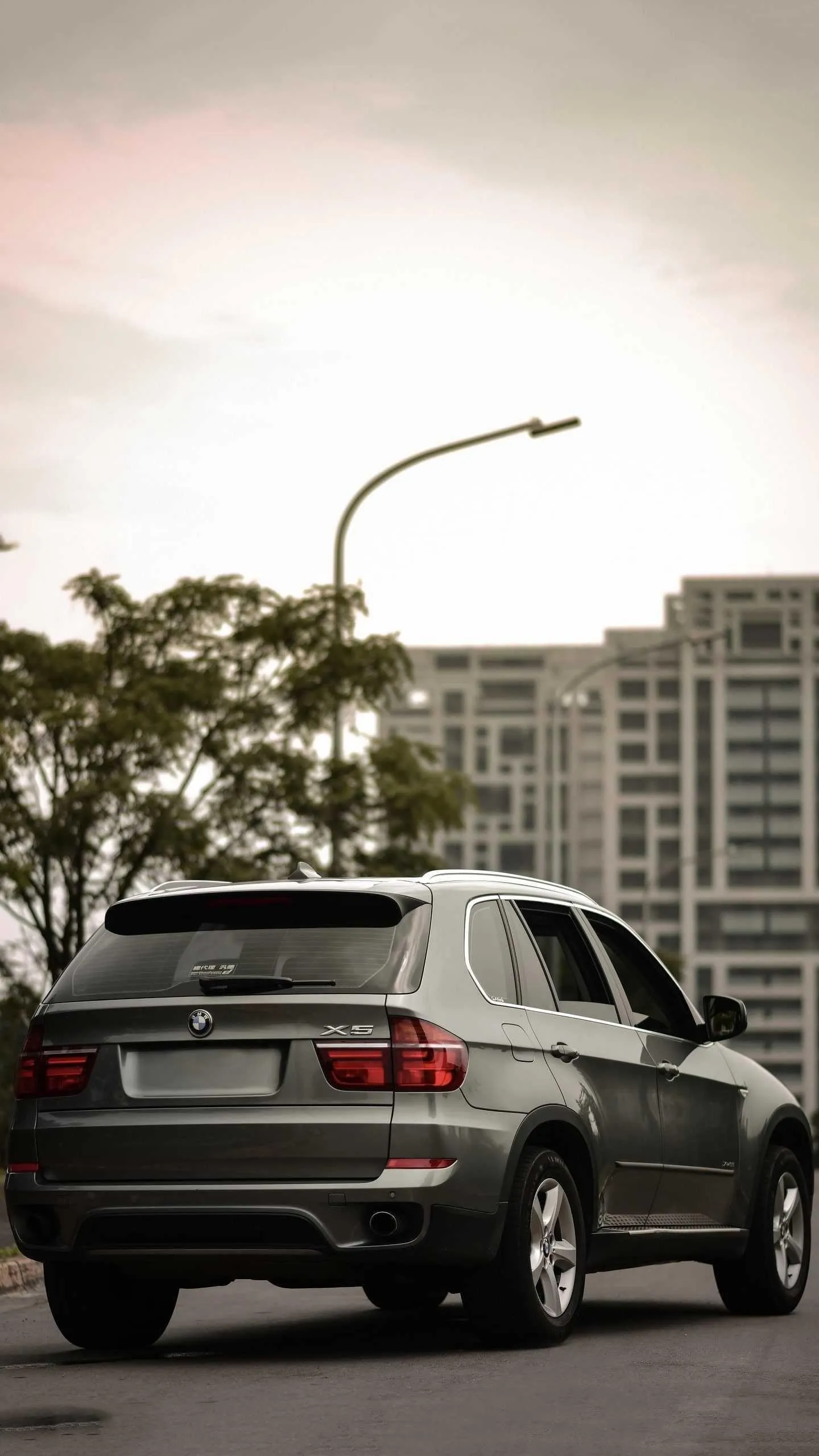 Bmw X5 Driving Through the Streets of an Urban Cityscape