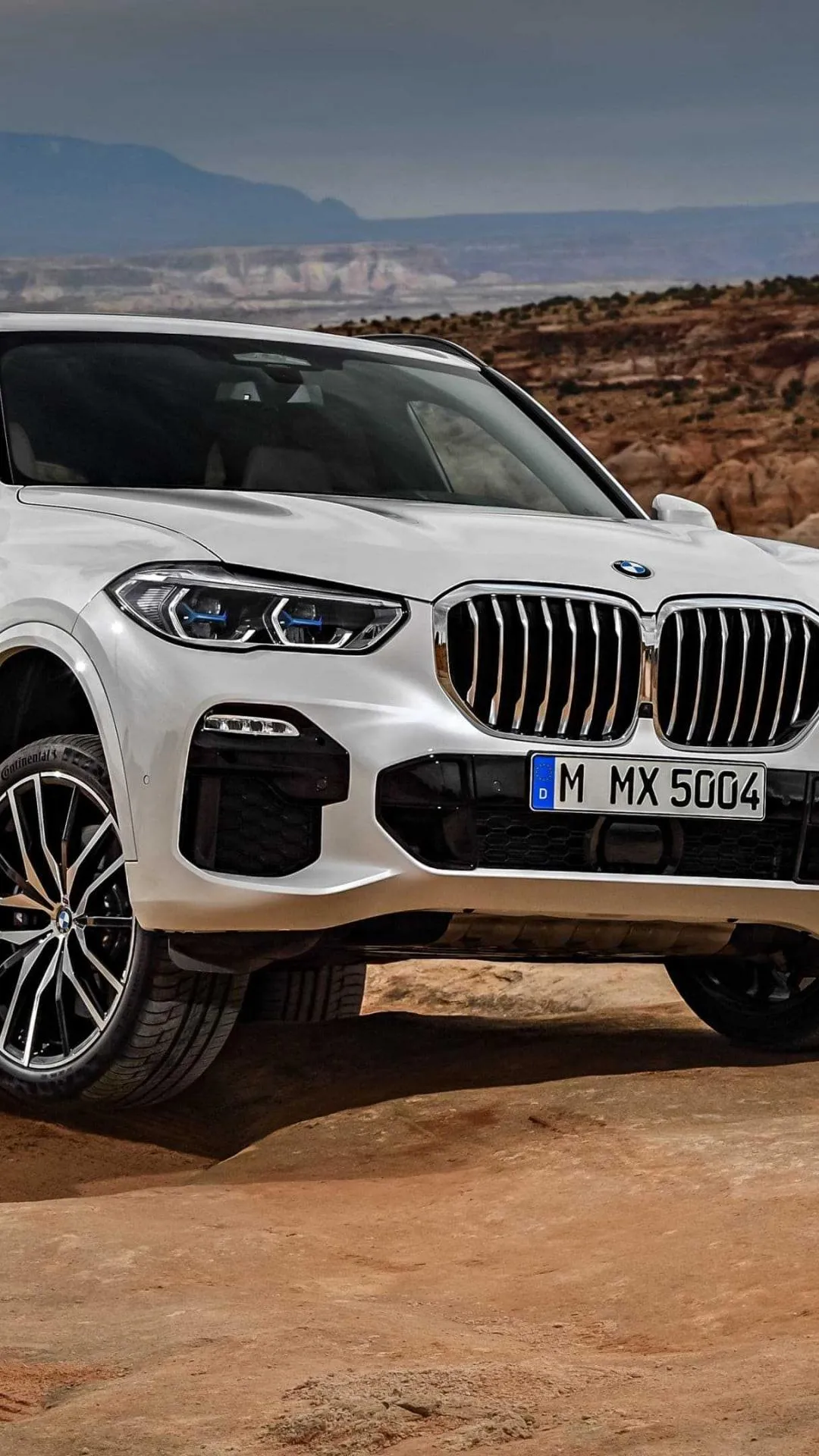 Bmw X5 Off Roading in Rugged Terrain with Mountains Image