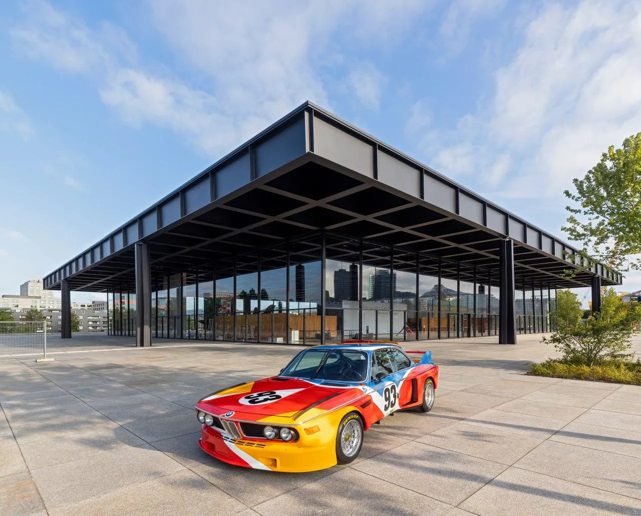 Bmw Z4 on Open Road with Modern Architecture Wallpaper