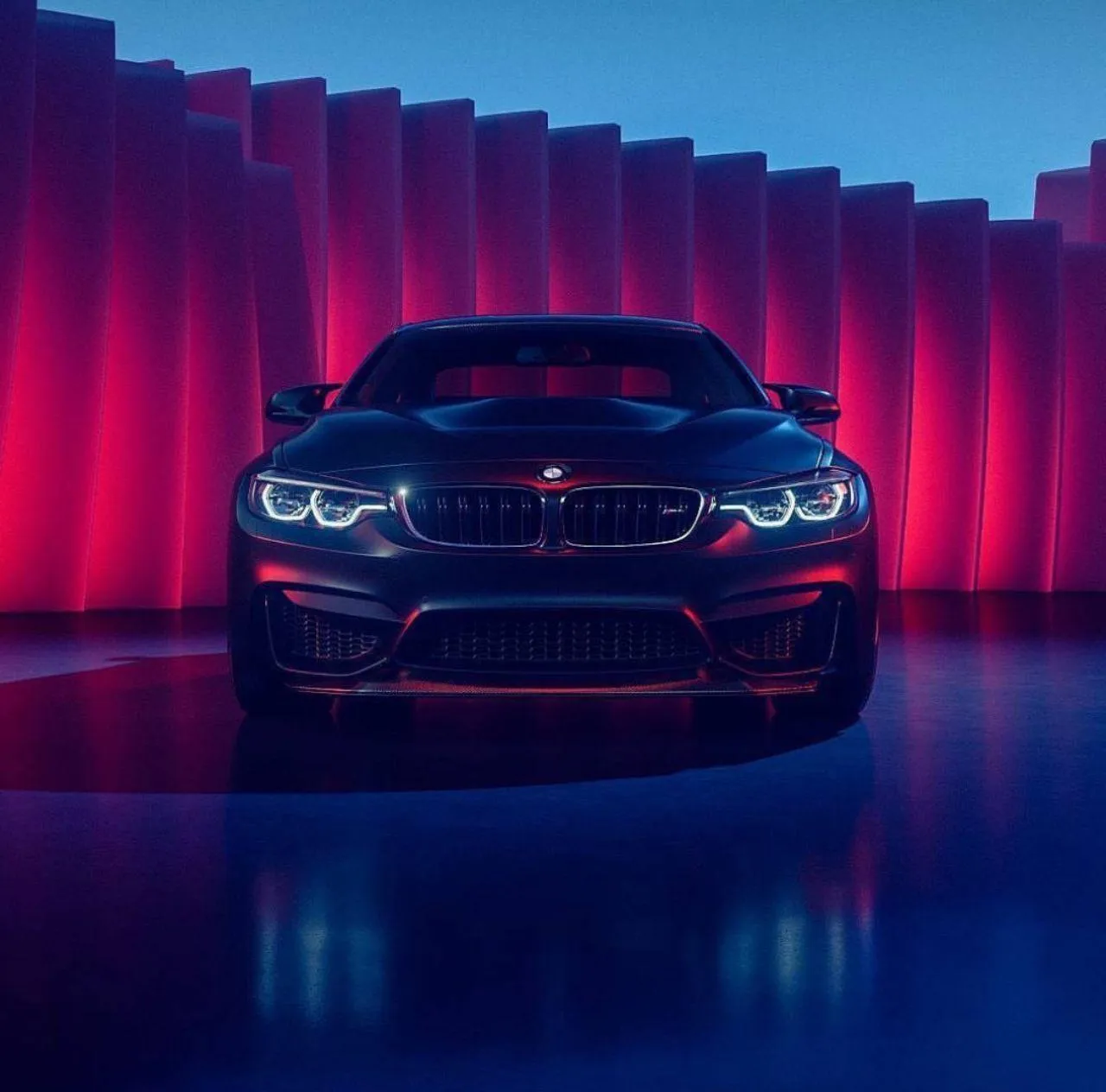 Bold Red Bmw Illuminated By Vertical Neon Lighting Wallpaper