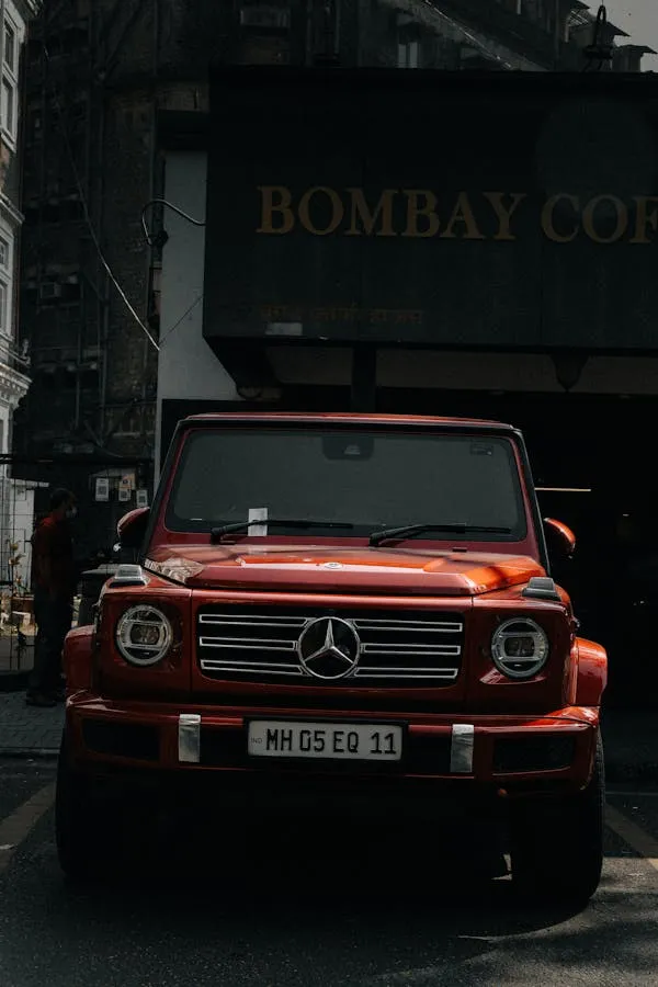 Bold Red Mercedes G Wagon in Front of Coffee Shop Wallpaper
