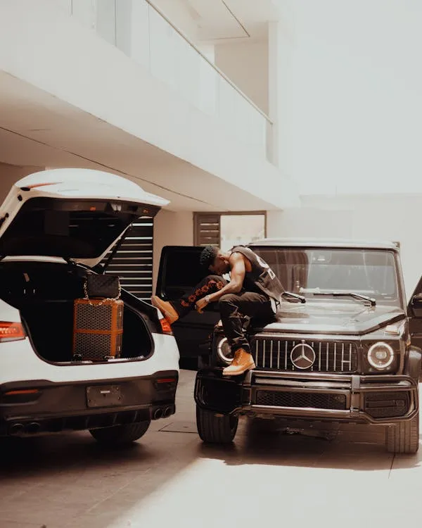 Boy posing with Mercedes G Wagon in Urban Area Wallpaper