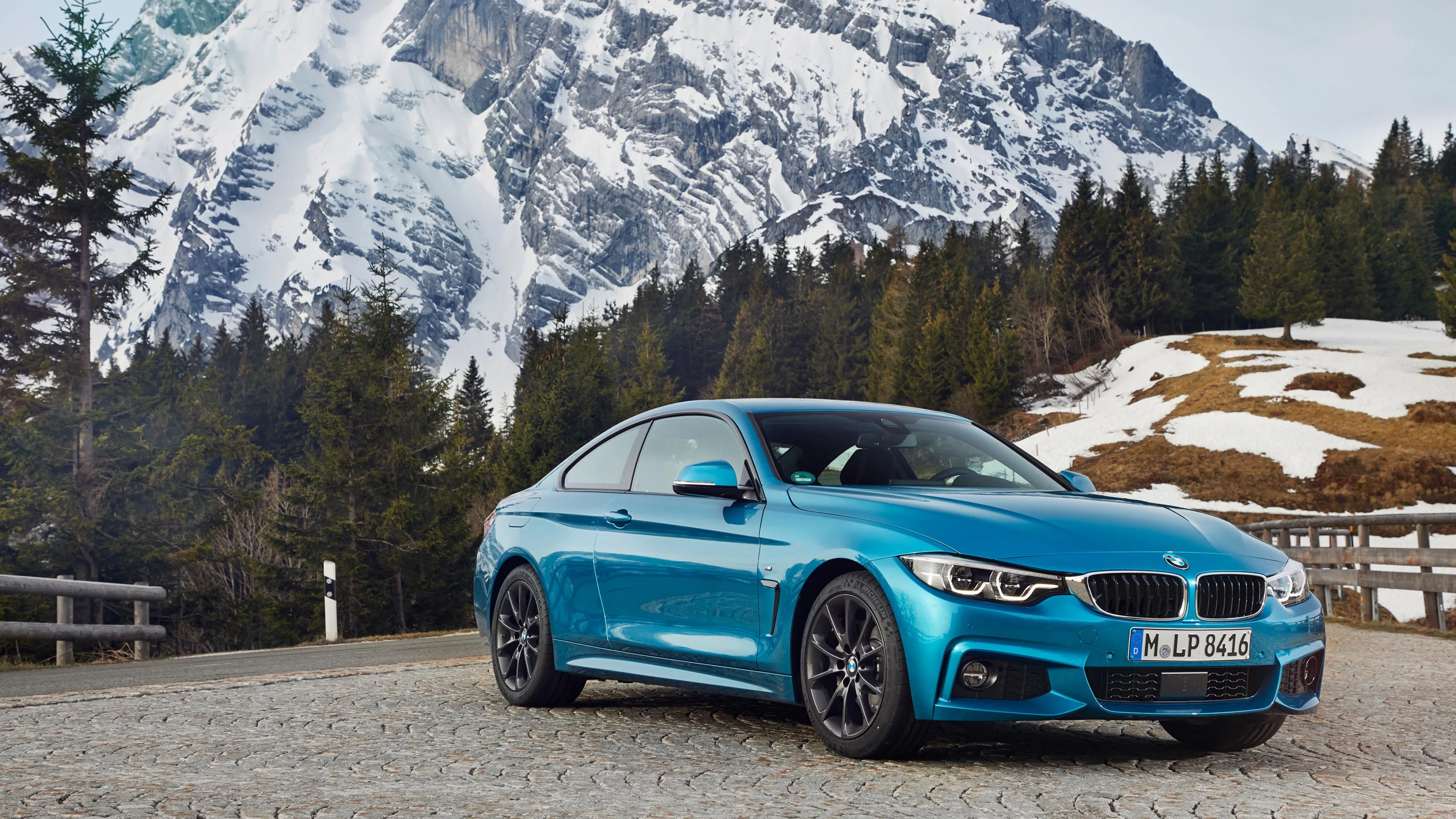 Bright Blue Bmw Parked in Snowy Mountain Landscape