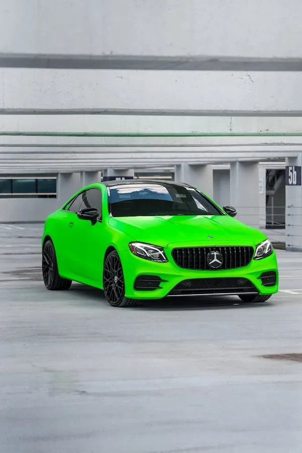 Bright Green AMG Mercedes Benz in Urban Parking Wallpaper