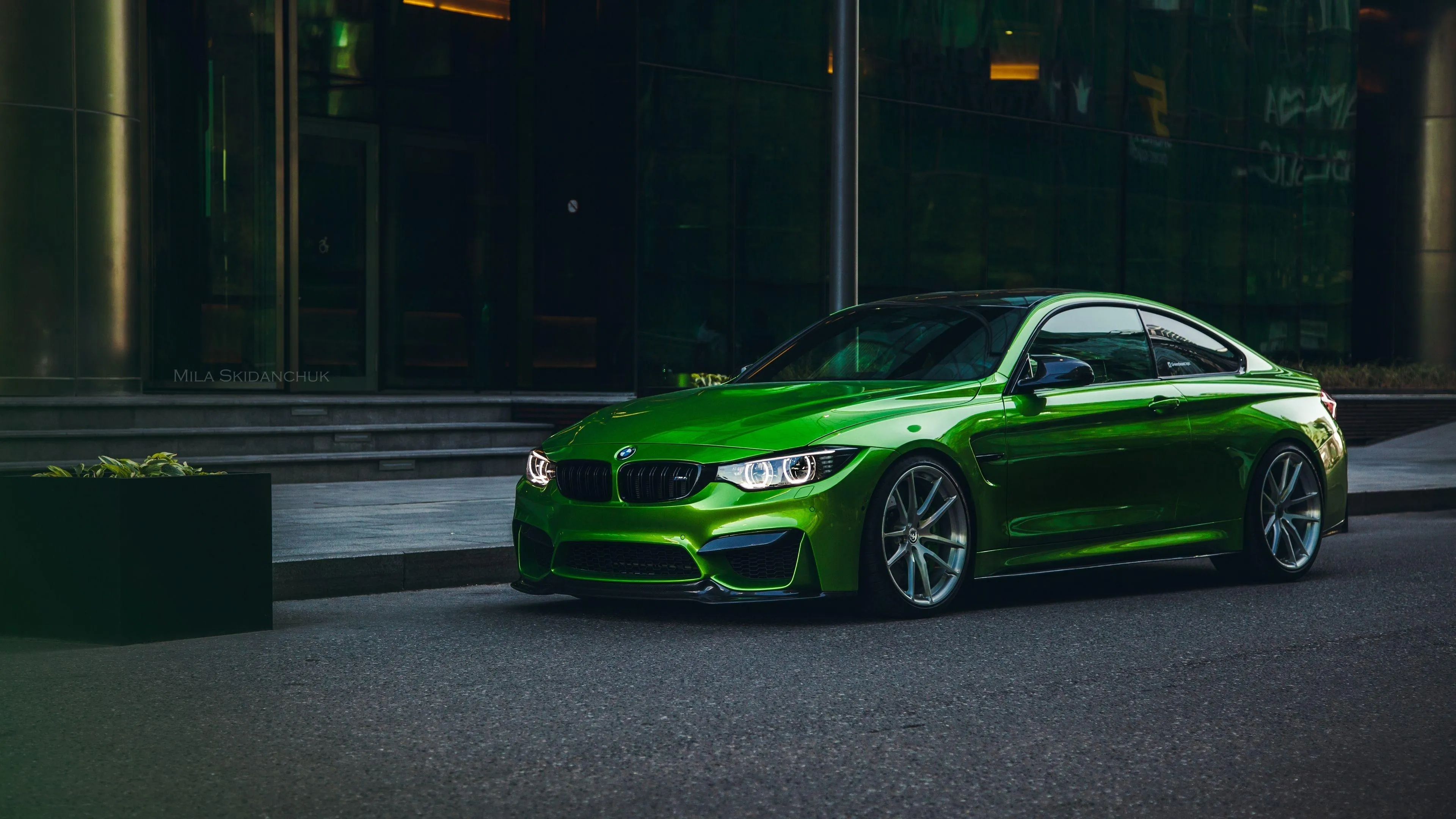 Bright Green Bmw Parked in Front of Modern Glass Image