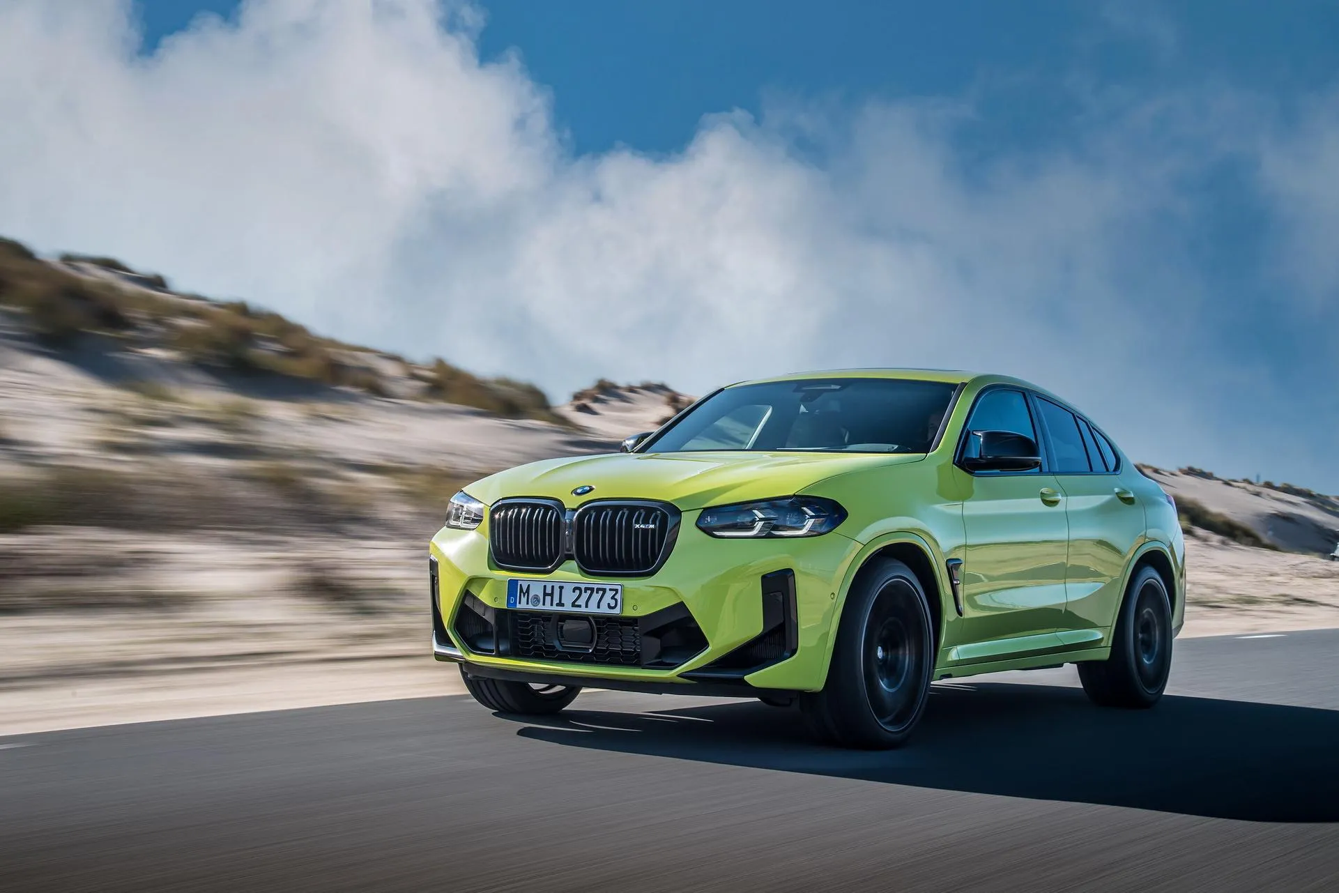 Bright Green Bmw X Model Speeding on Mountain Road Image