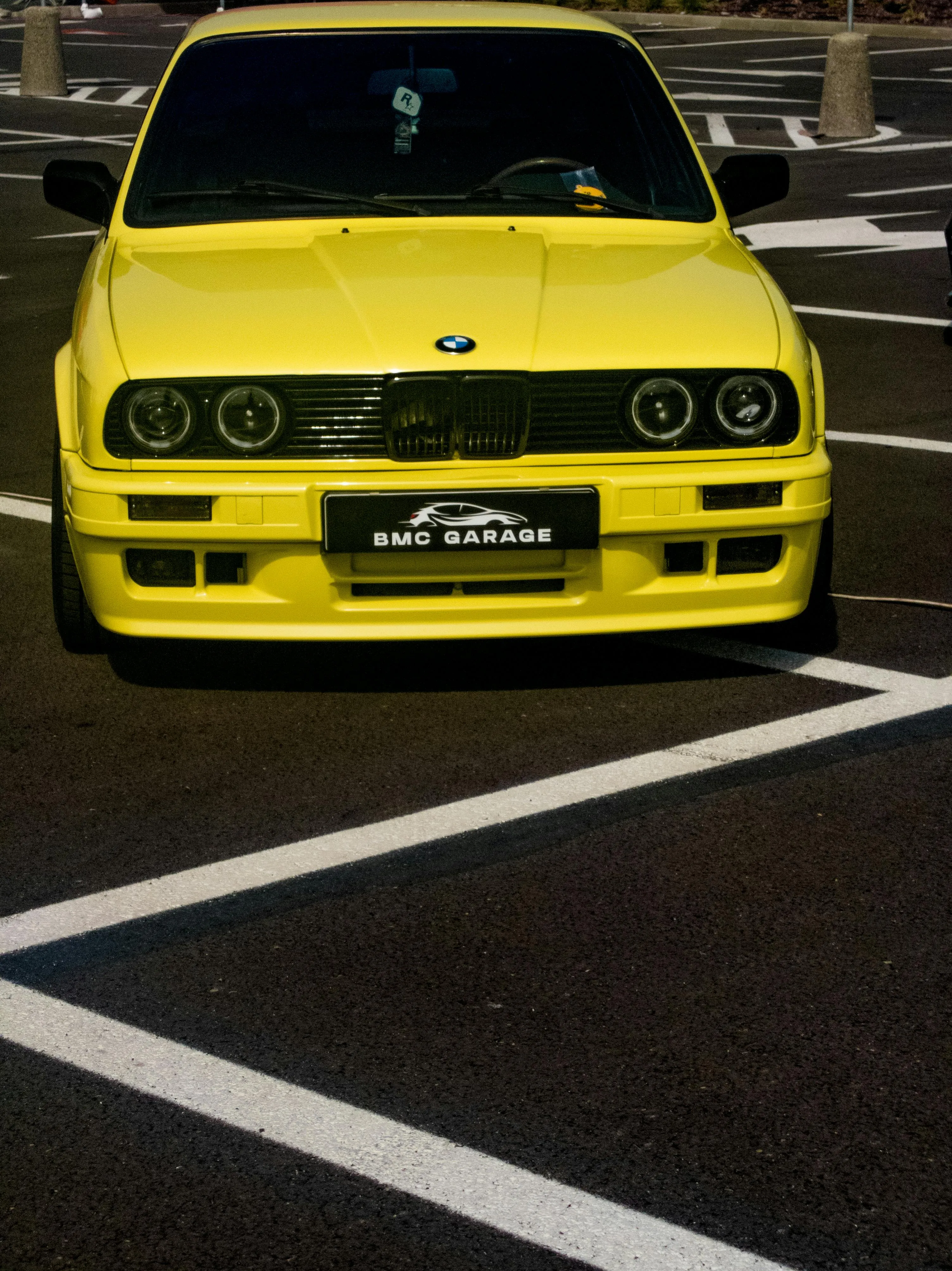Bright Yellow Bmw Parked Diagonally on Street Lines