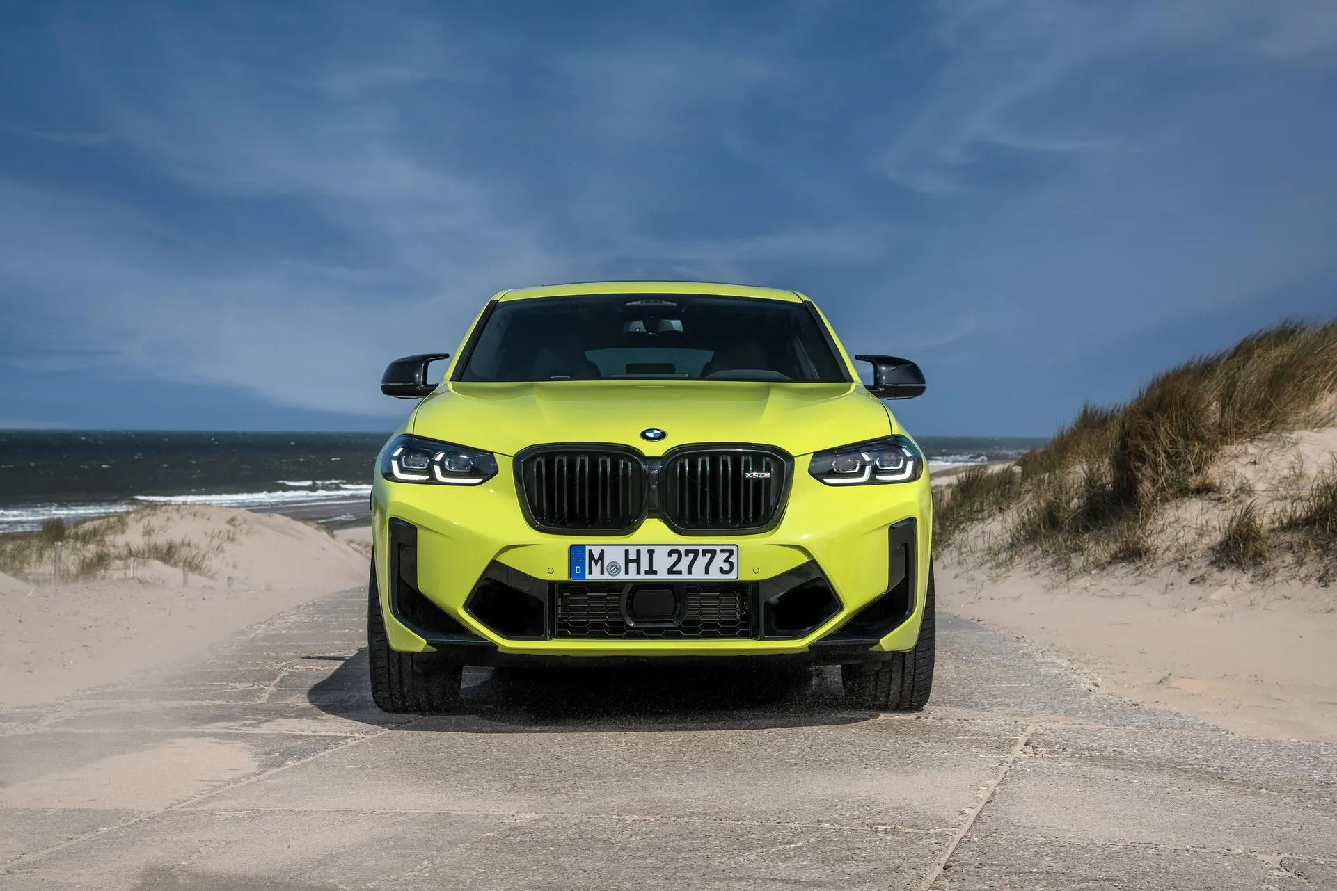 Bright Yellow Bmw Suv Parked on a Sandy Beach Hd Image