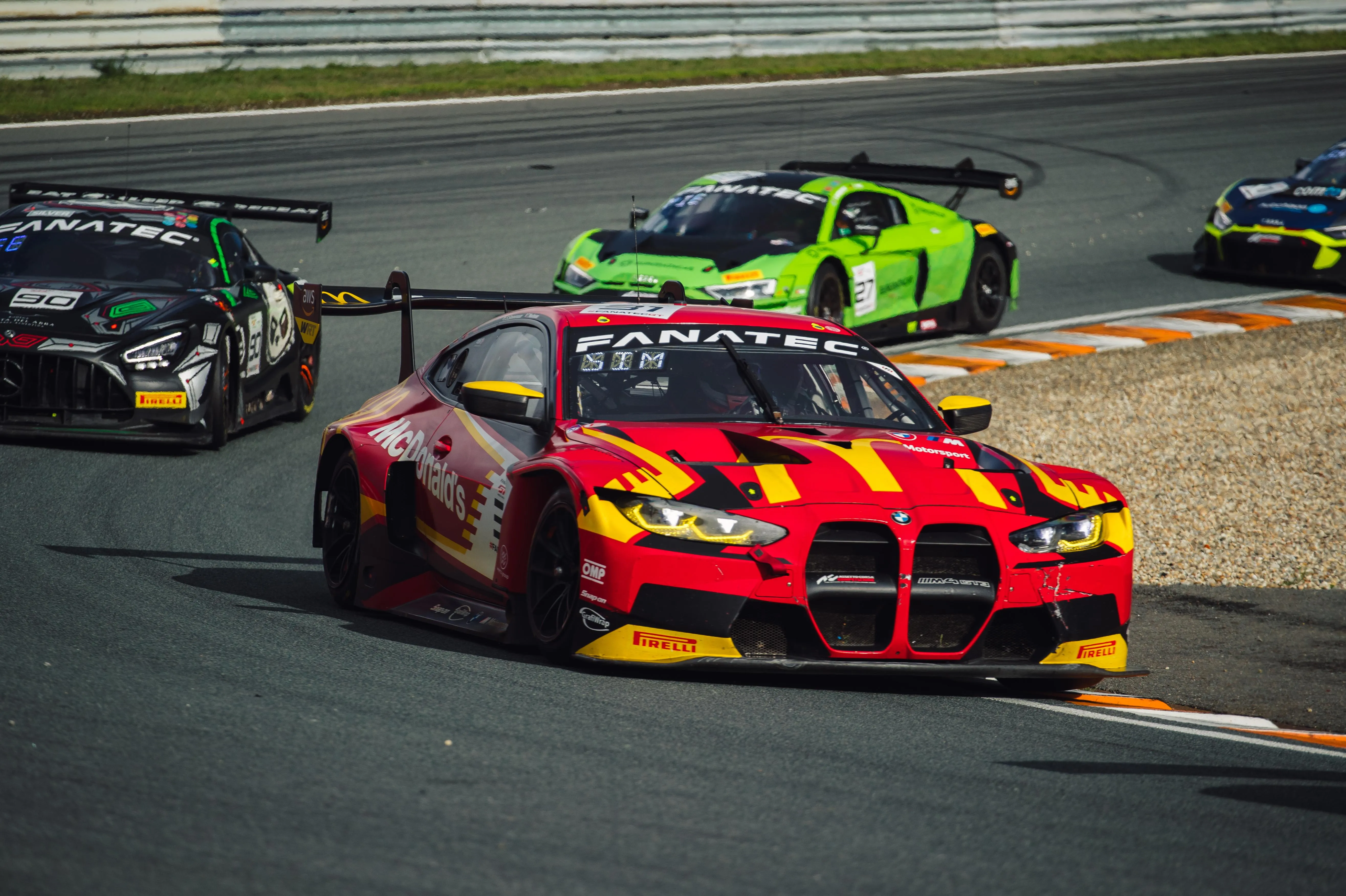 Brightly Colored Bmw Gt Cars Racing Around Track Image