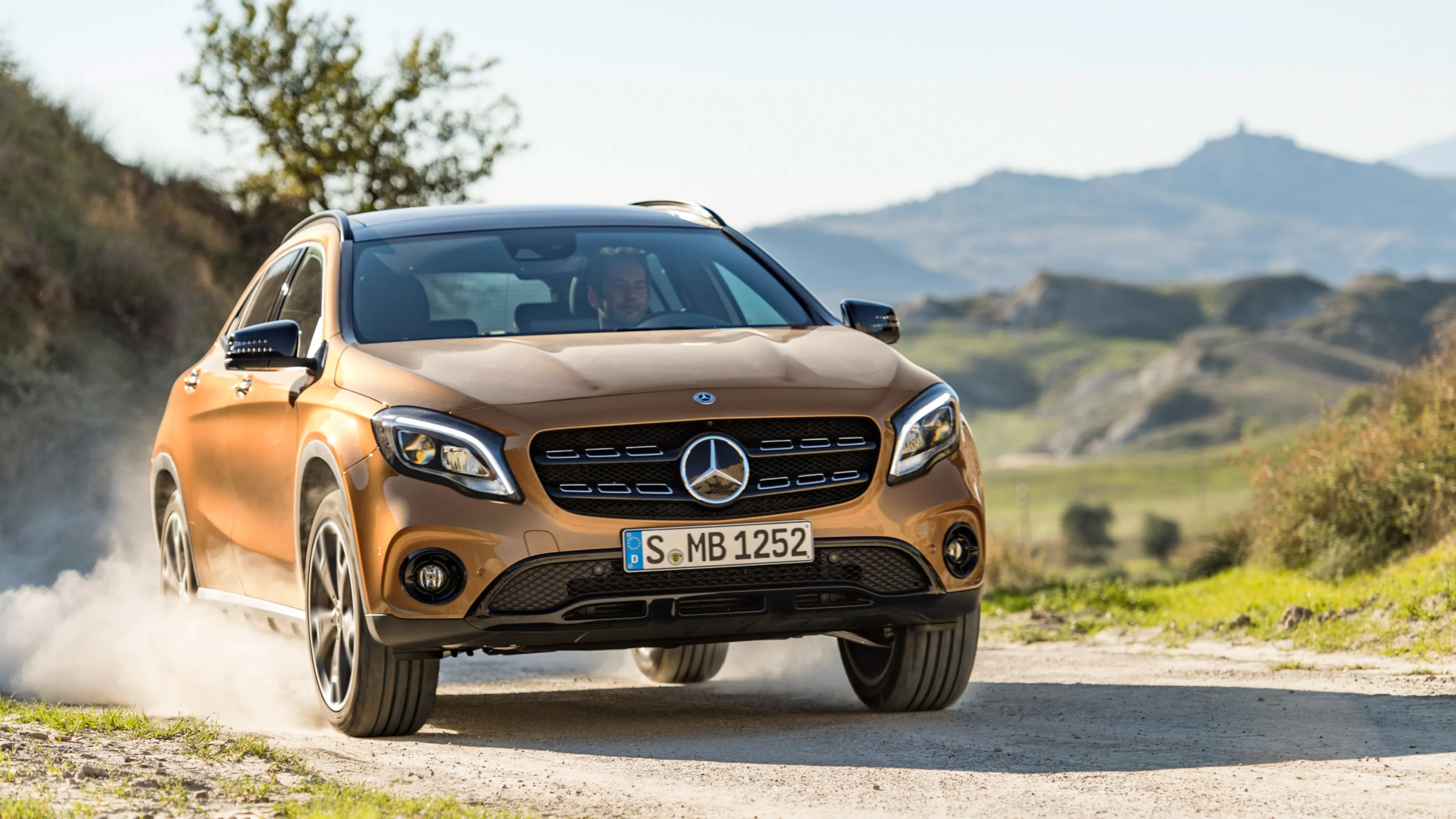 Bronze Mercedes Benz SUV Driving Offroad in Scenic Hills