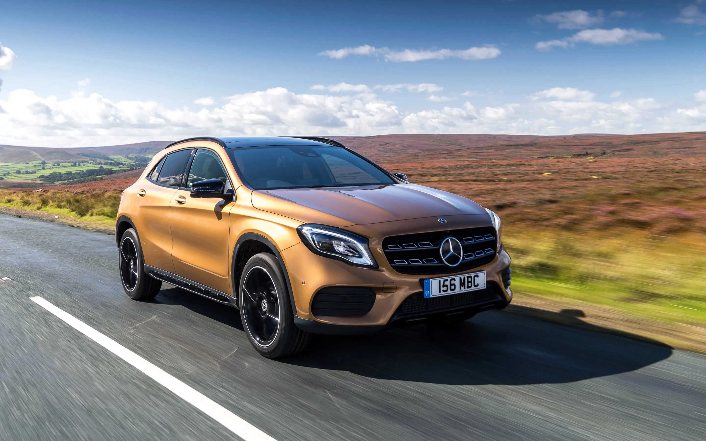 Bronze Mercedes Benz SUV Driving on Open Road image
