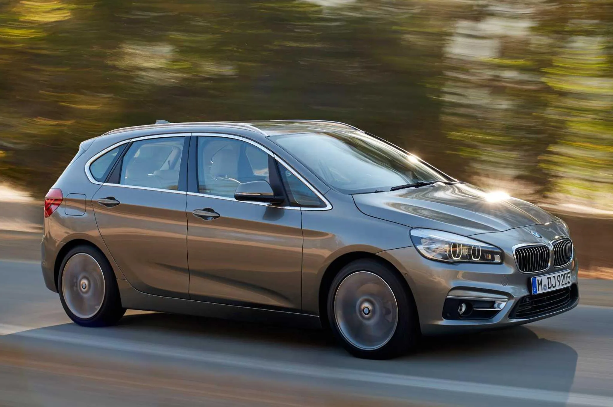 Brown Bmw Hatchback in Motion Through a Green Forest Hd