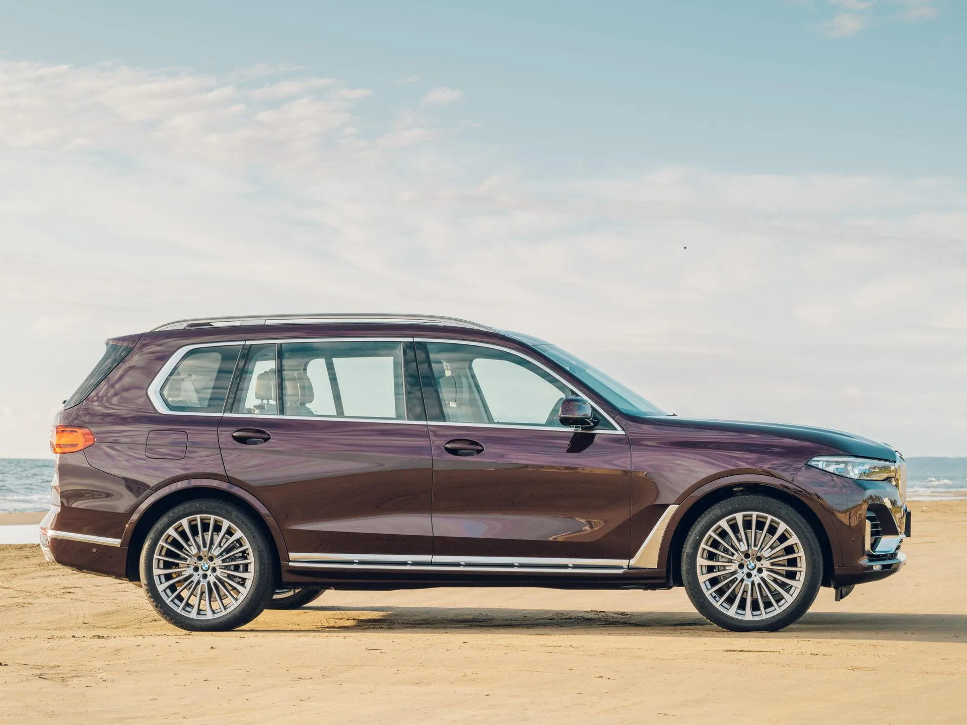 Brown Bmw Suv Parked on Grass with Clear Sky Behind