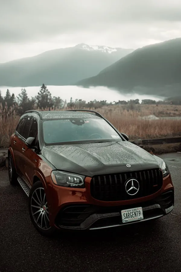 Brown Mercedes Benz SUV with Scenic Mountain View Wallpaper