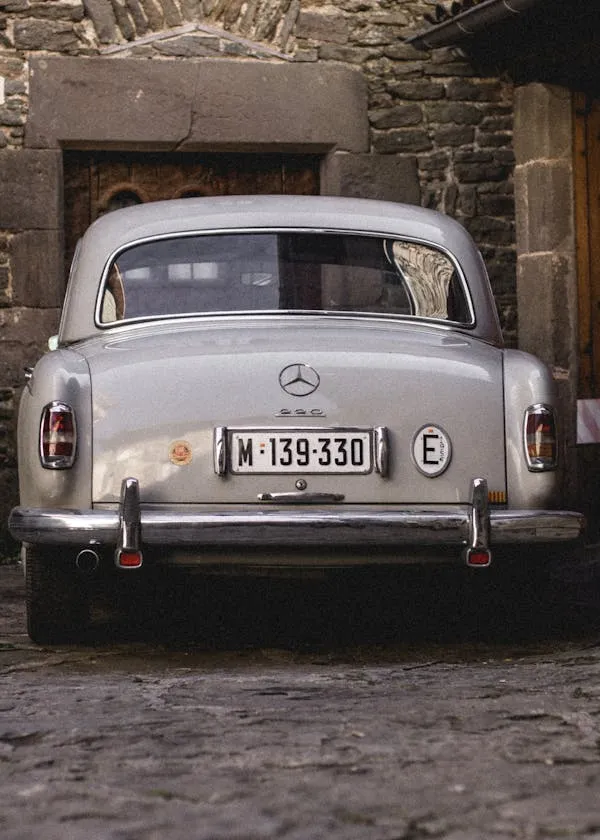 Classic Benz Backside View Near Stone Wall Garage Wallpaper