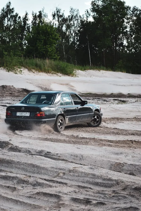 Classic Benz Kicking Up Sand on Rural Road Adventure image