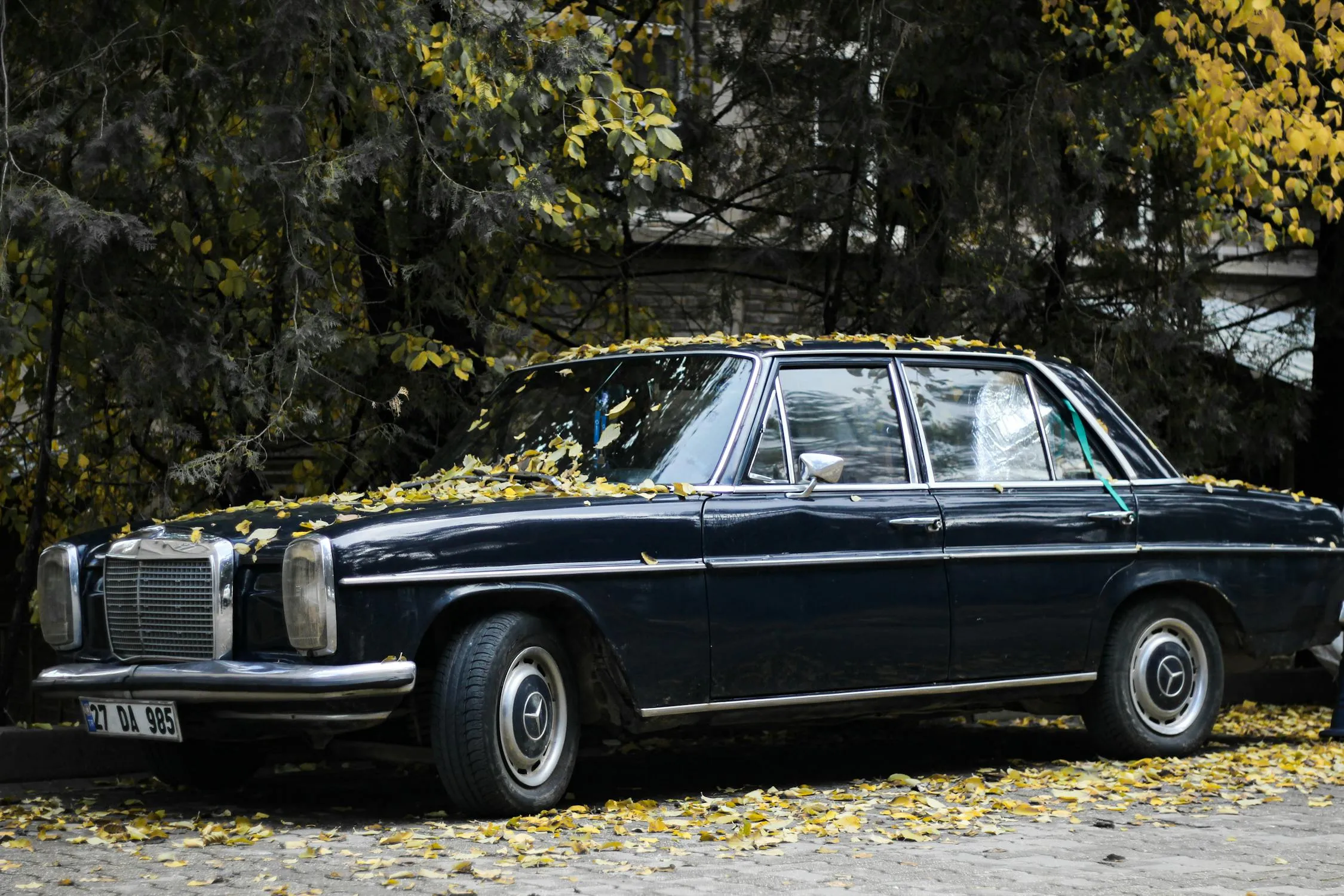 Classic black Mercedes Benz car parked on a quiet street