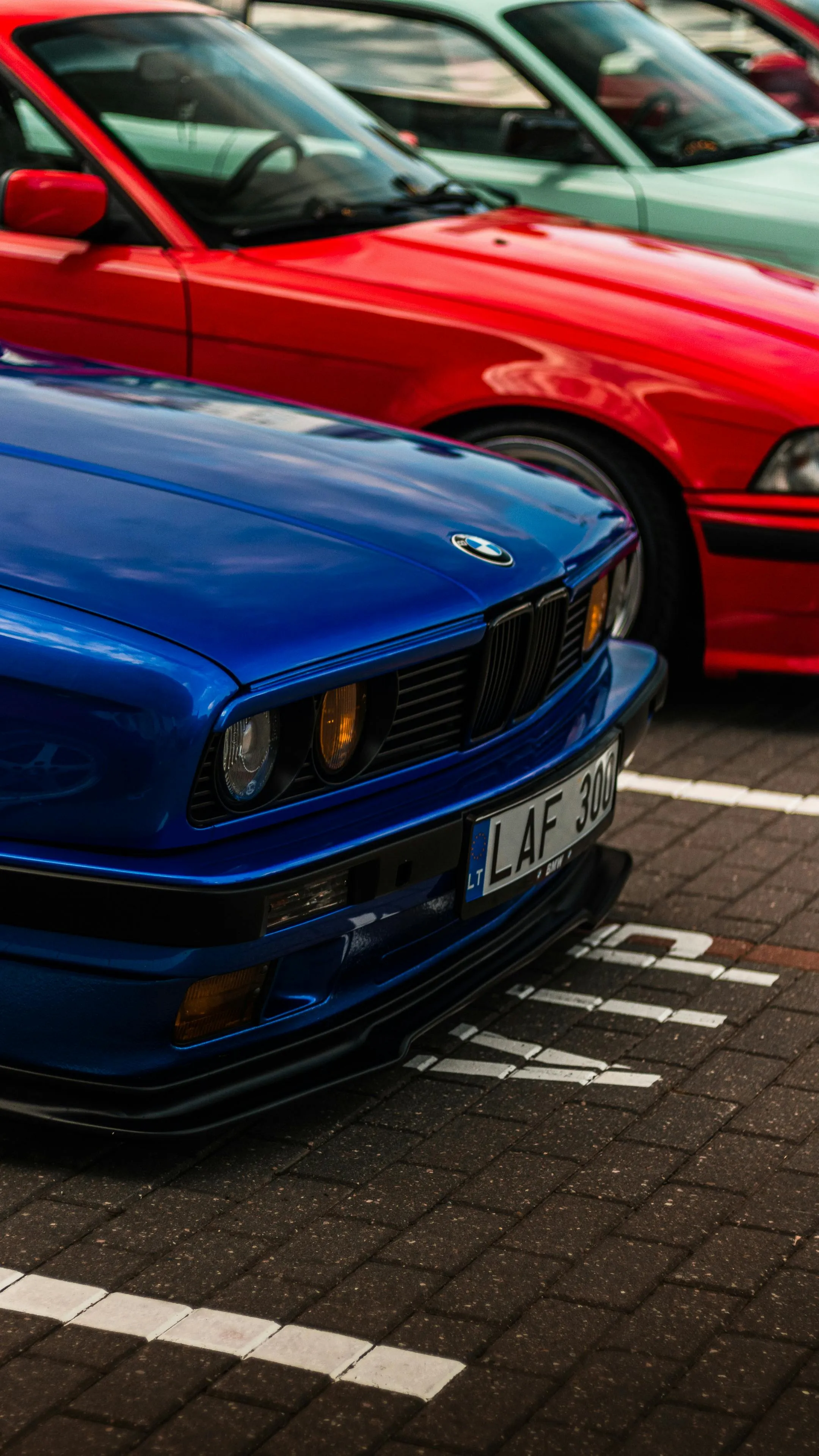 Classic Blue Bmw Parked Among Other Cars on Pavement