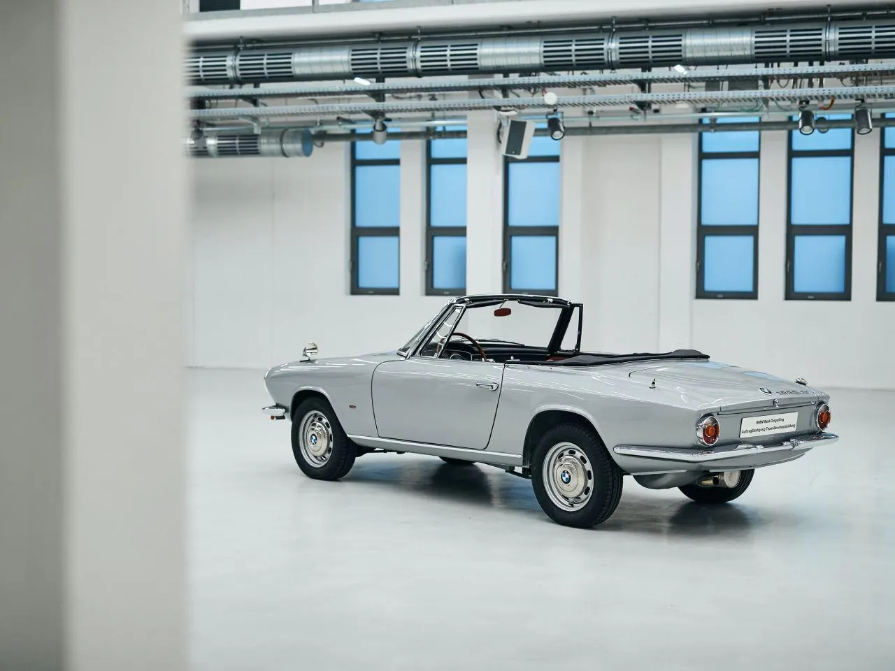 Classic Bmw Convertible in Bright Indoor Showroom Wallpaper