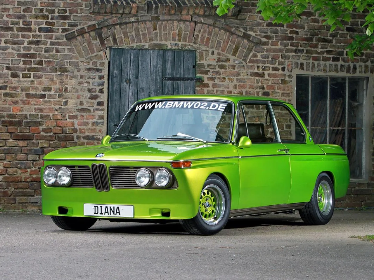 Classic Bmw Driving Through an Industrial Street Wallpaper