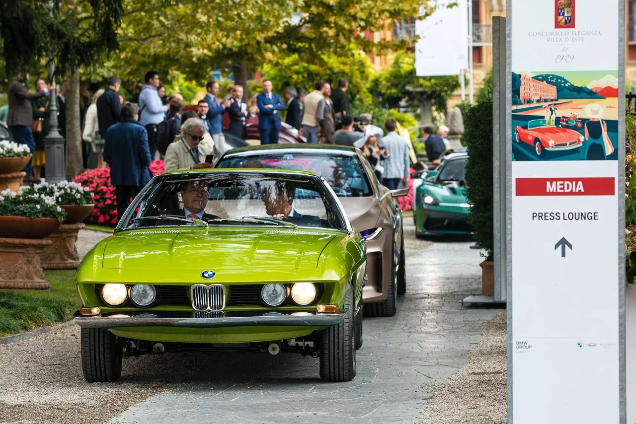 Classic Bmw Model Parked at a Fueling Station Wallpaper