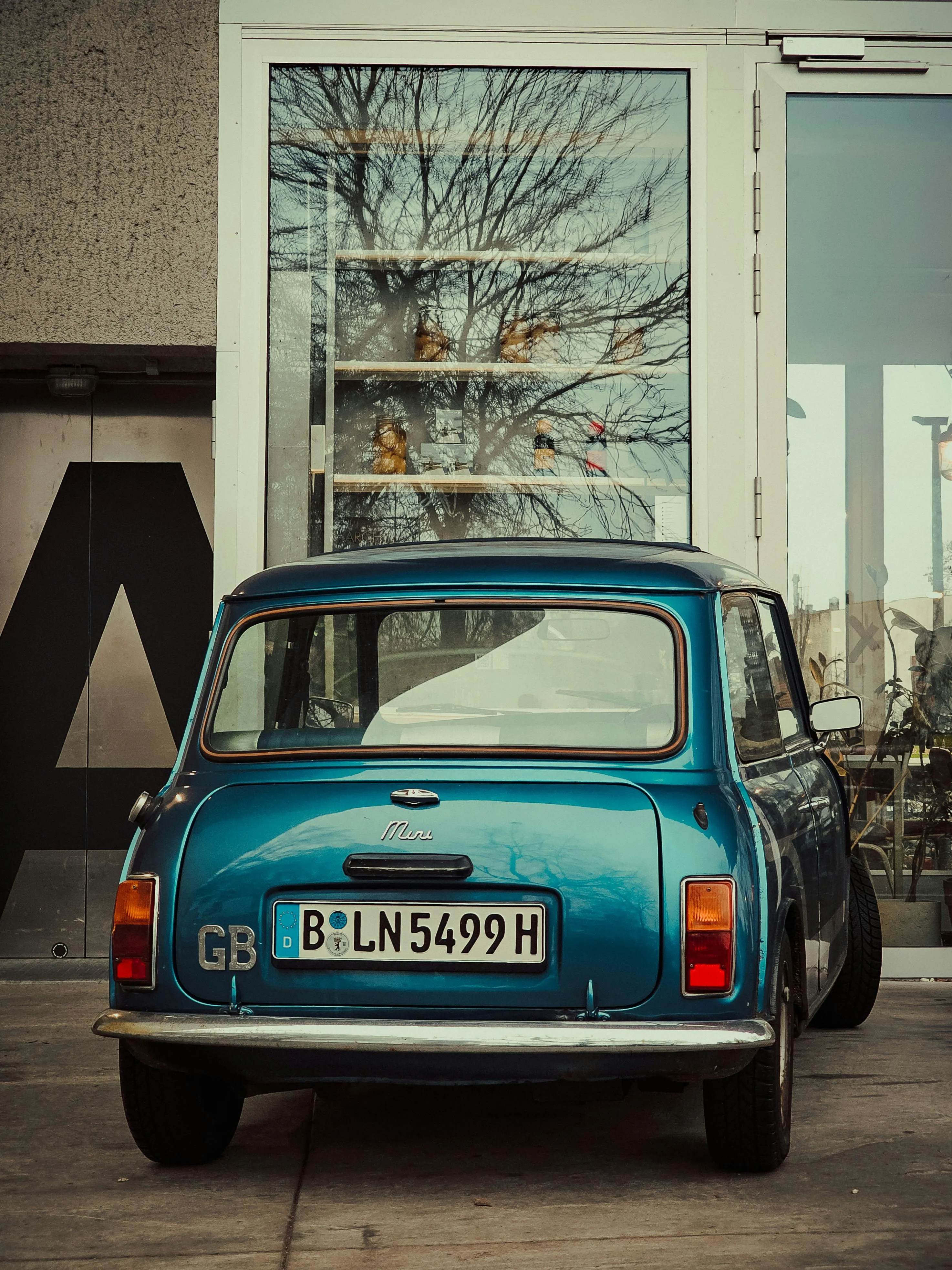 Classic Bmw Parked Outside a Modern Glass Building Entrance