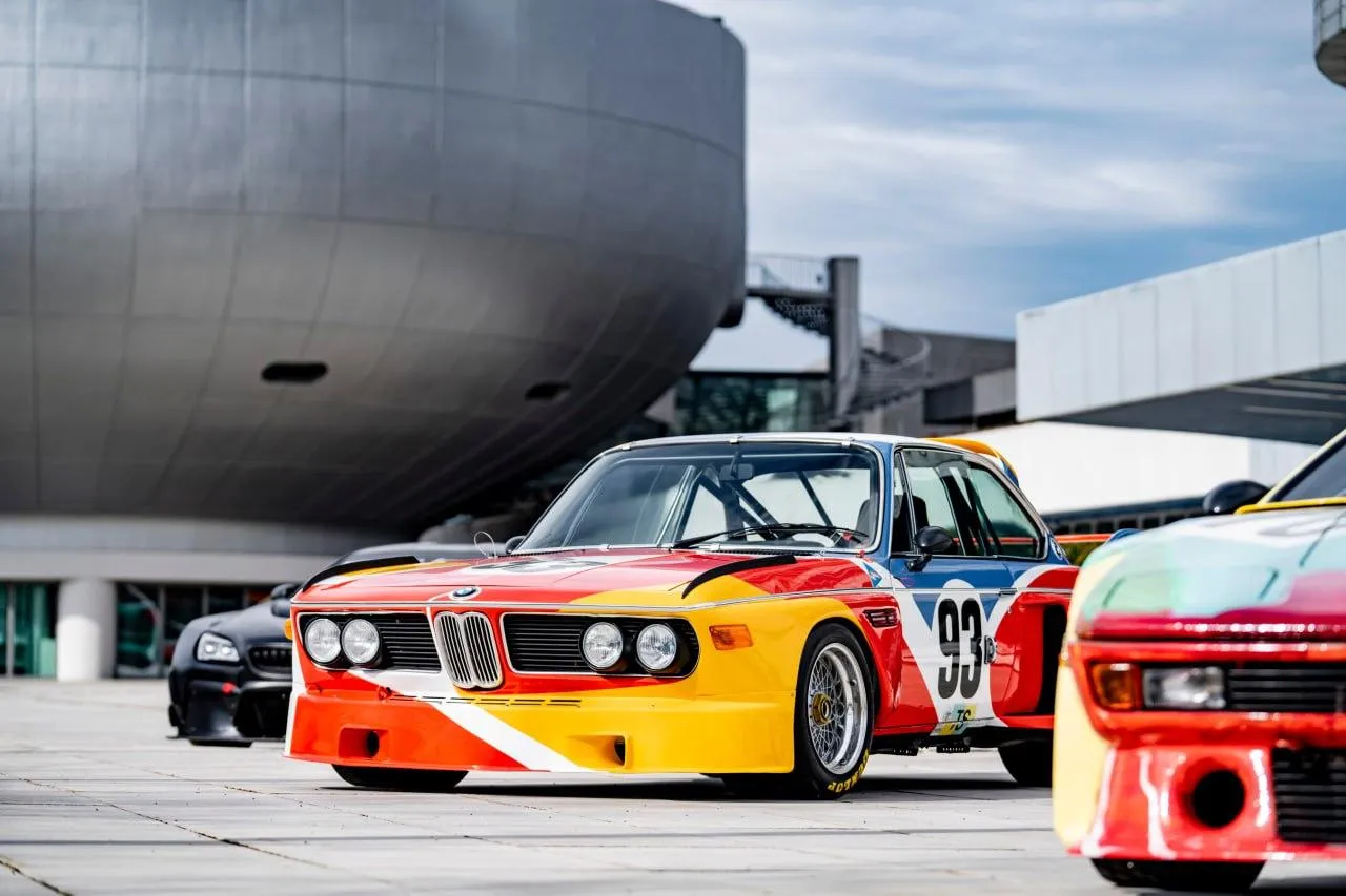 Classic Bmw Race Cars Parked in Outdoor Area Wallpaper
