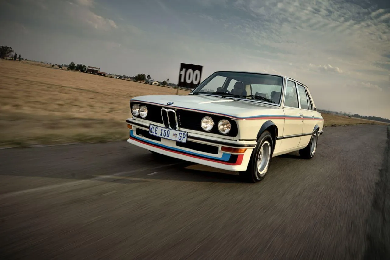 Classic Bmw Racing on Desert Road Kicking Up Dust Trail