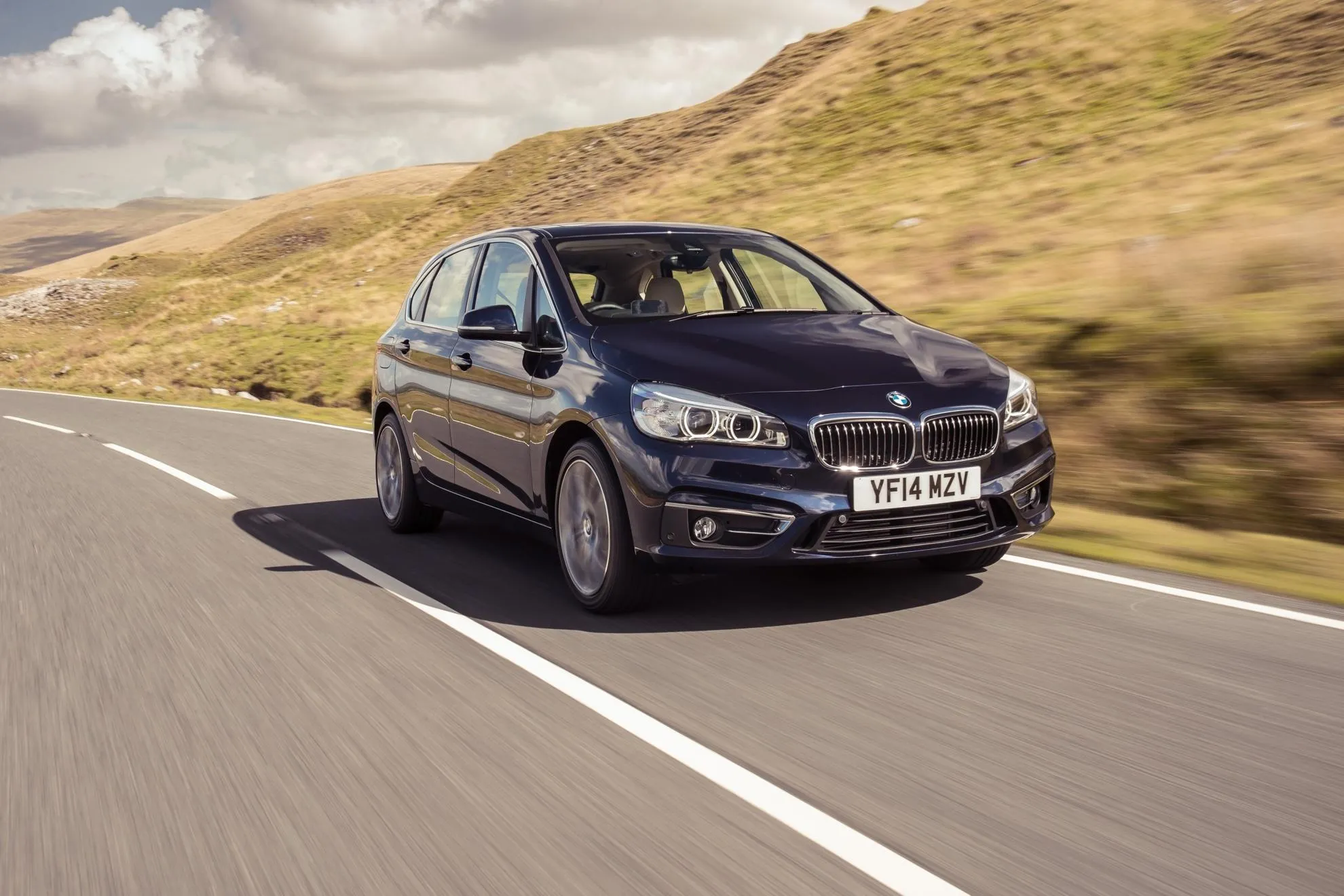 Classic Bmw Sedan Driving Through Open Countryside