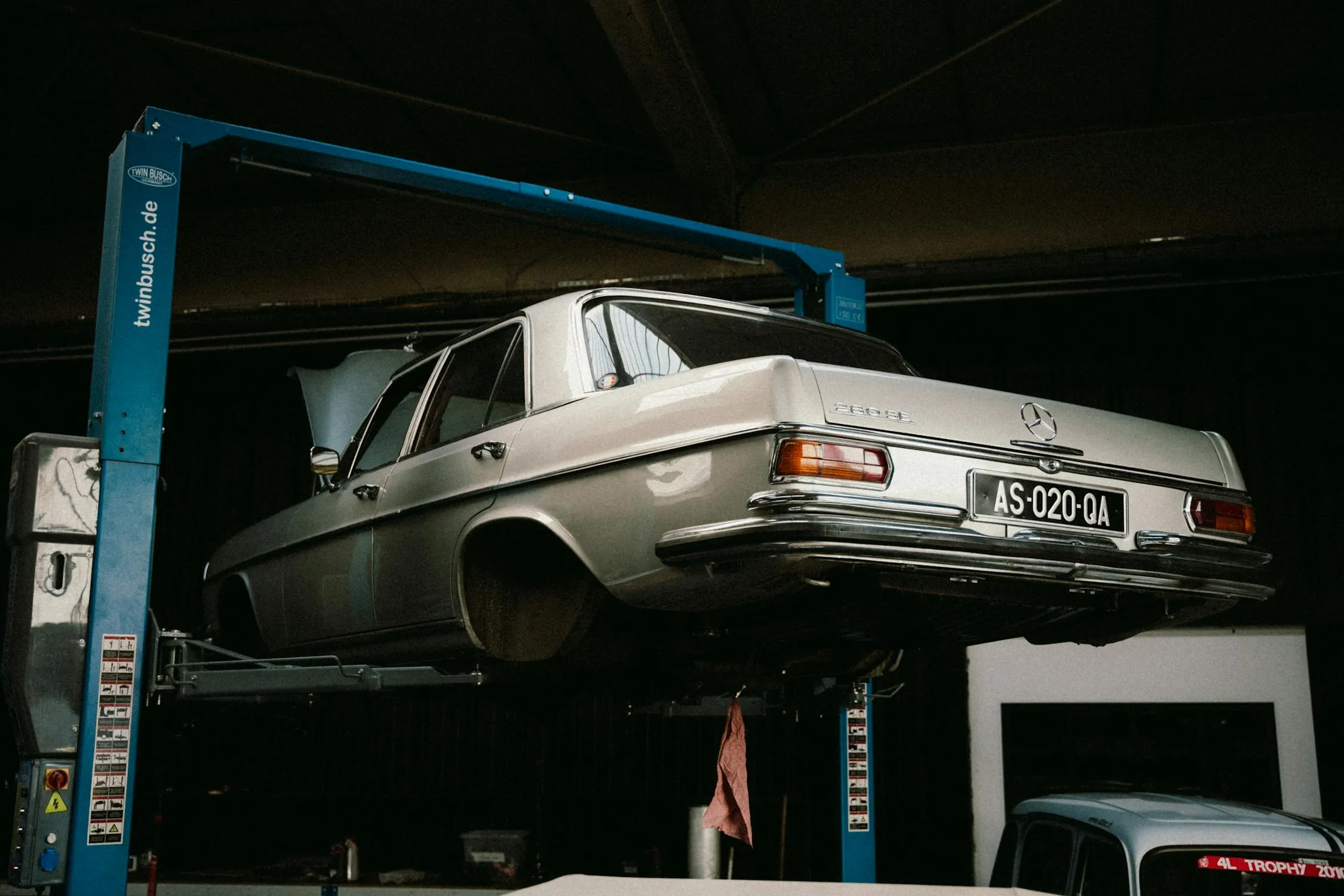 Classic Mercedes Benz Car Lifted in Professional Garage