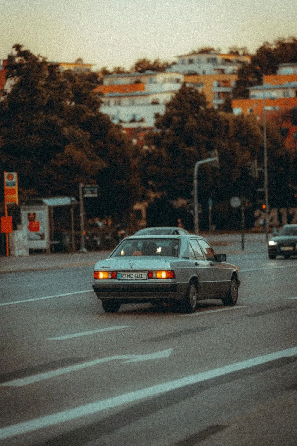 Classic Mercedes Benz Driving on Urban City Road Wallpaper