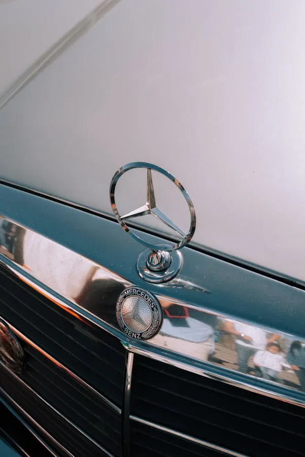 Classic Mercedes Benz Emblem on Glossy Hood Wallpaper
