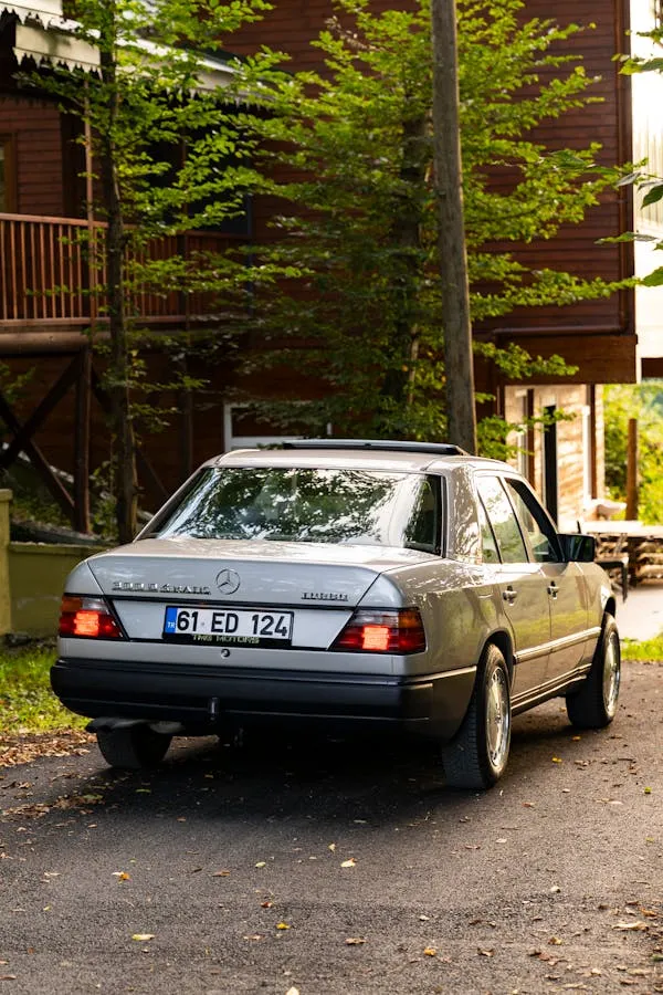 Classic Mercedes Benz Parked Near Wooden Cabin Outdoors