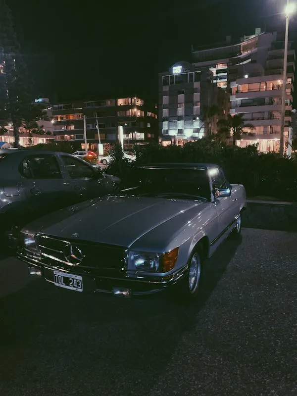 Classic Mercedes Benz Parked Under City Night Lights image