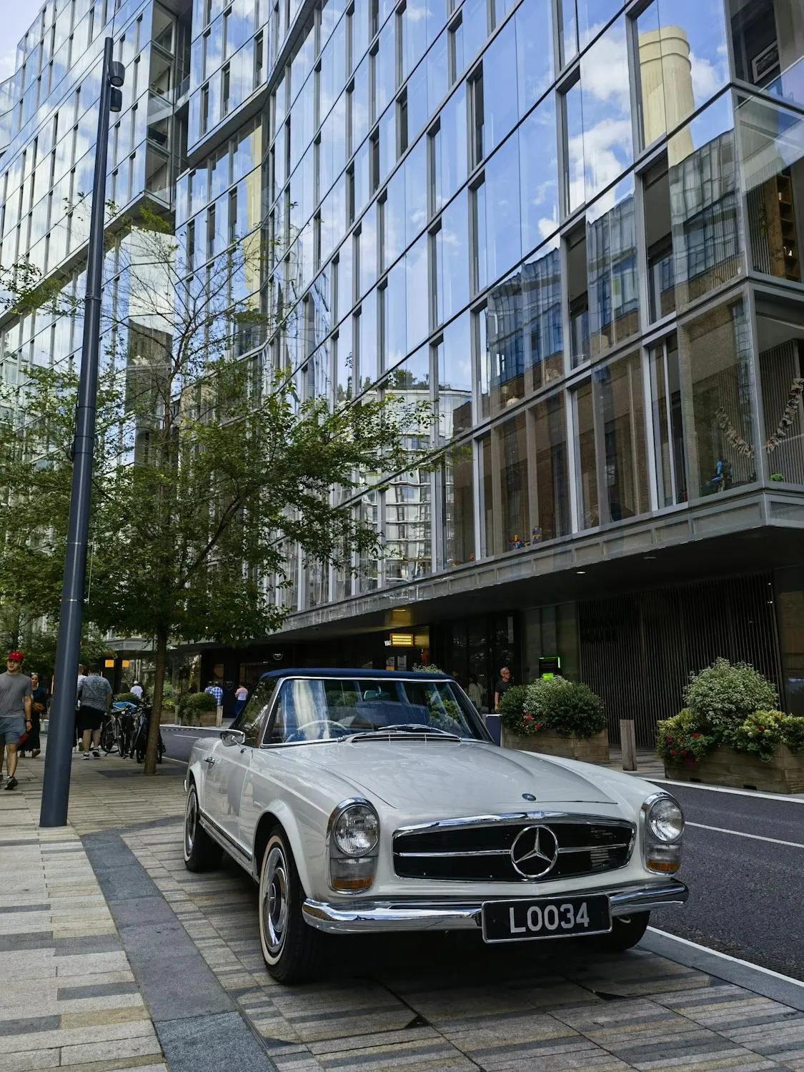 Classic Mercedes on Modern City Street Corner Wallpaper