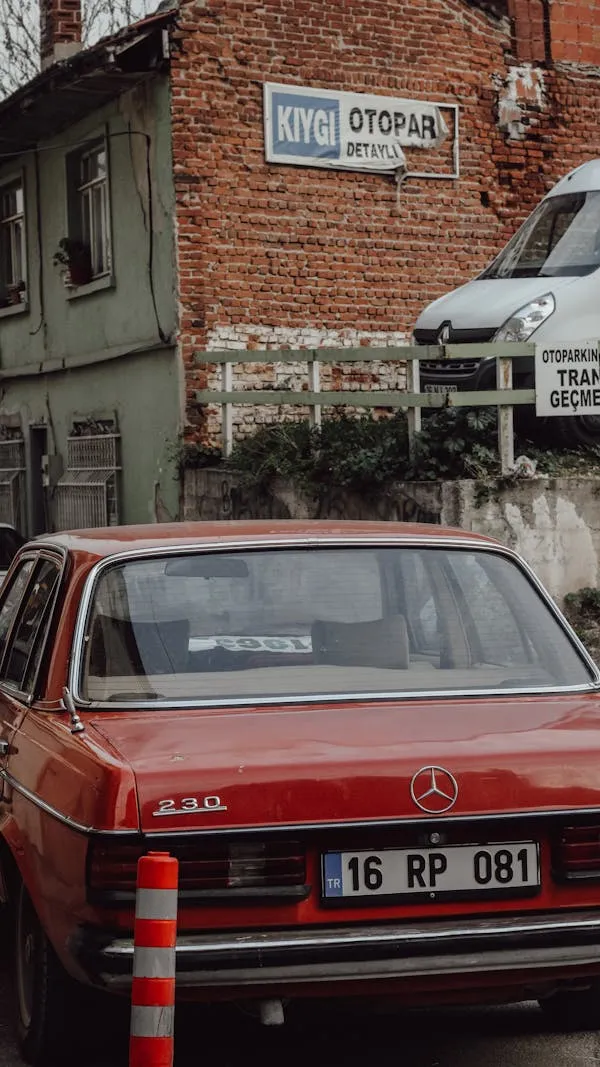 Classic Red Mercedes Benz Parked in Front of Brick House