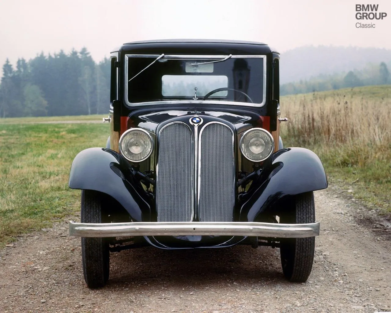Classic Vintage Bmw Car Parked on Country Road Wallpaper