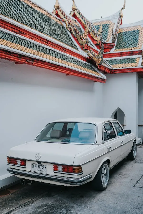 Classic White Benz Parked Near Temple Architecture image