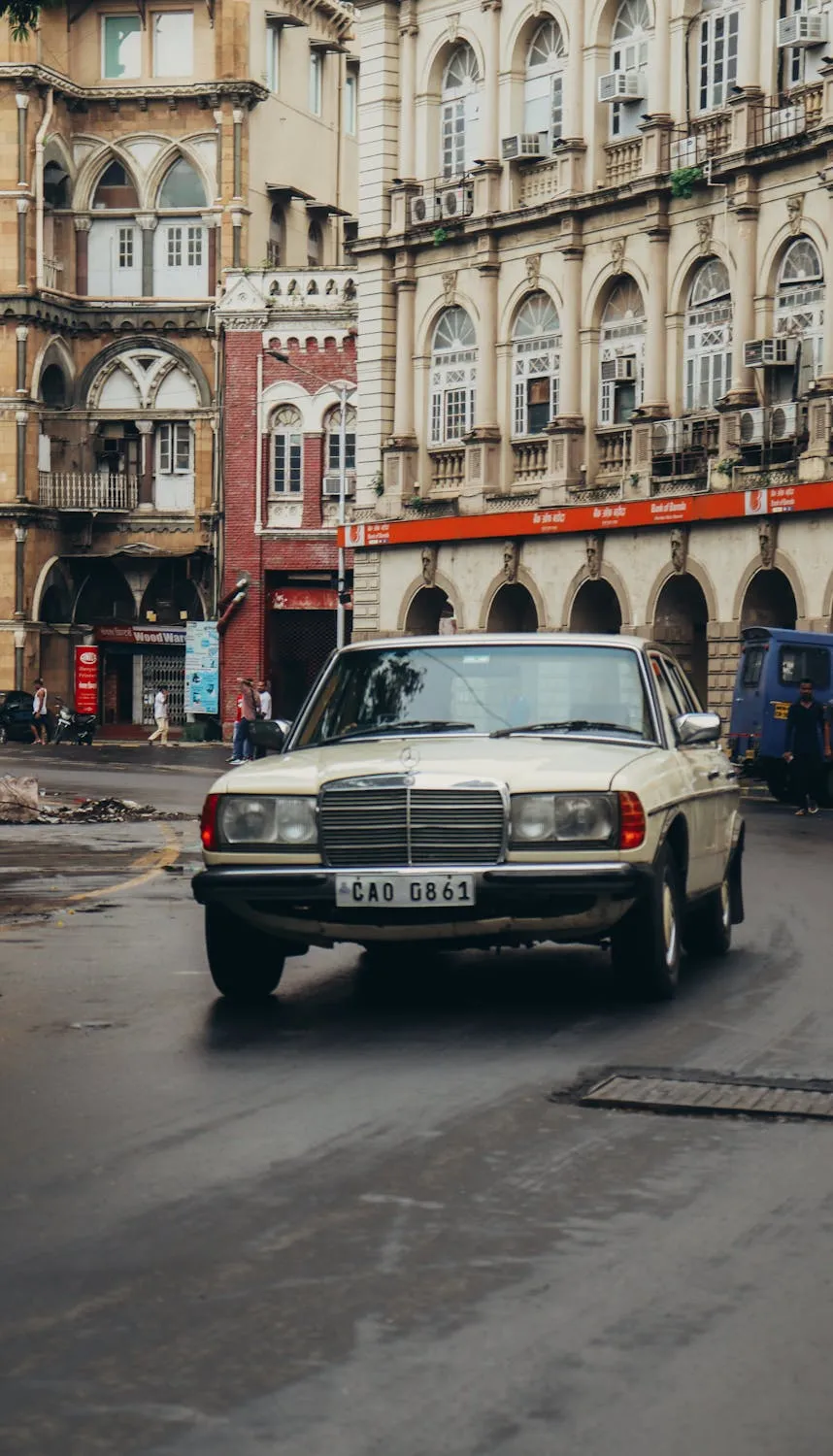 Classic White Mercedes Cruising Through European City