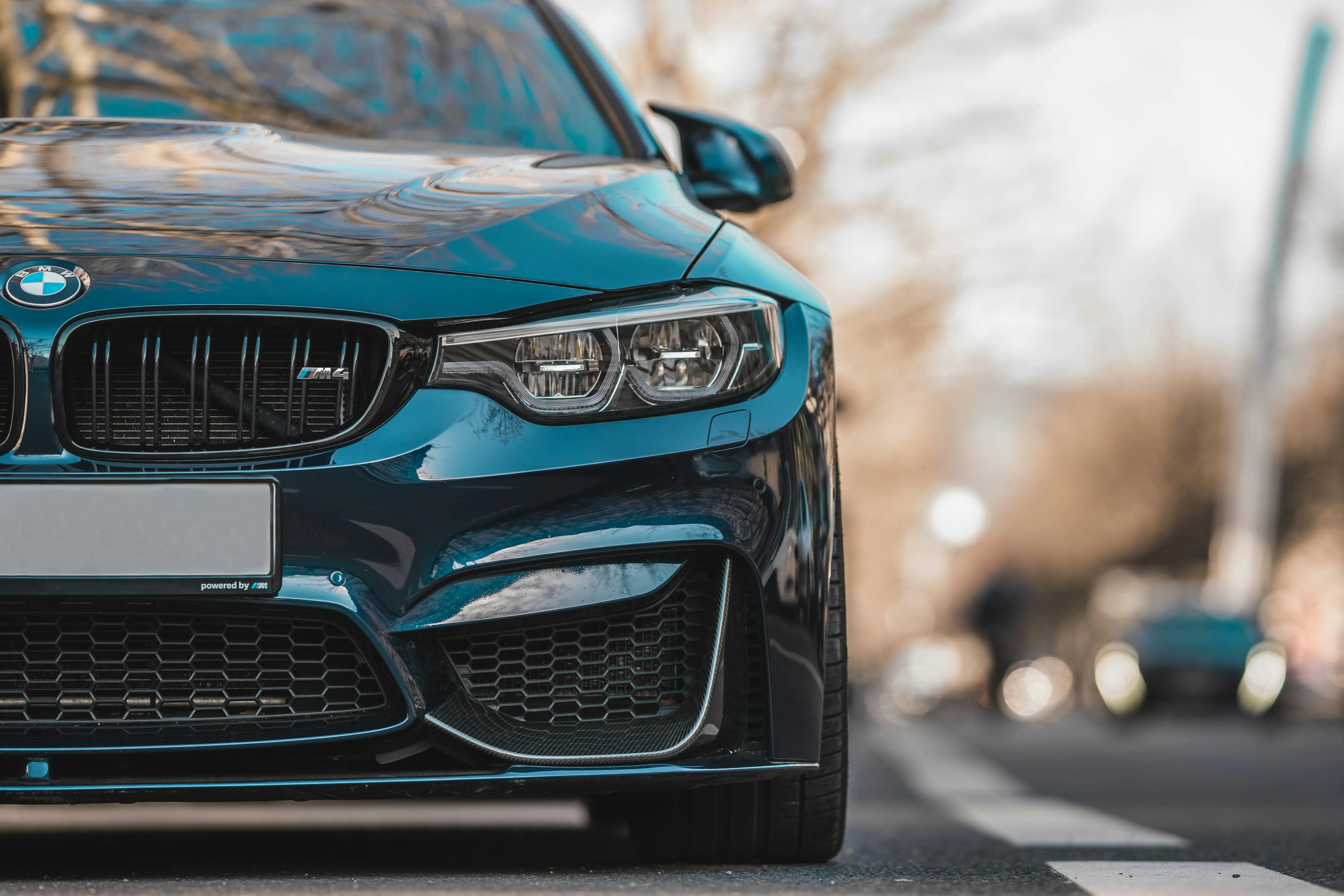 Close Up Front View of Teal Bmw in City Traffic Scene