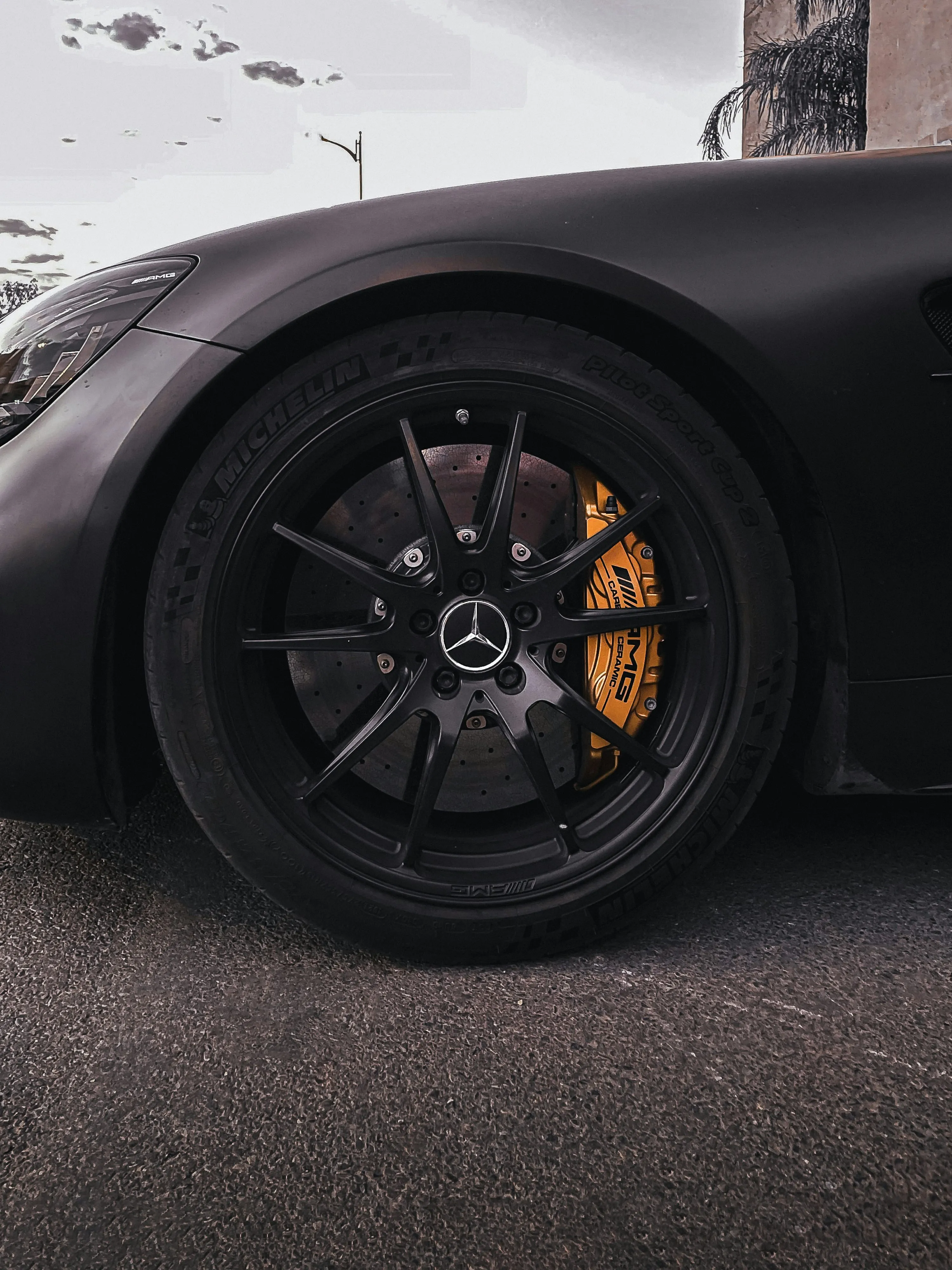 Close Up of Black Mercedes Benz Wheel with Yellow Brake Caliper