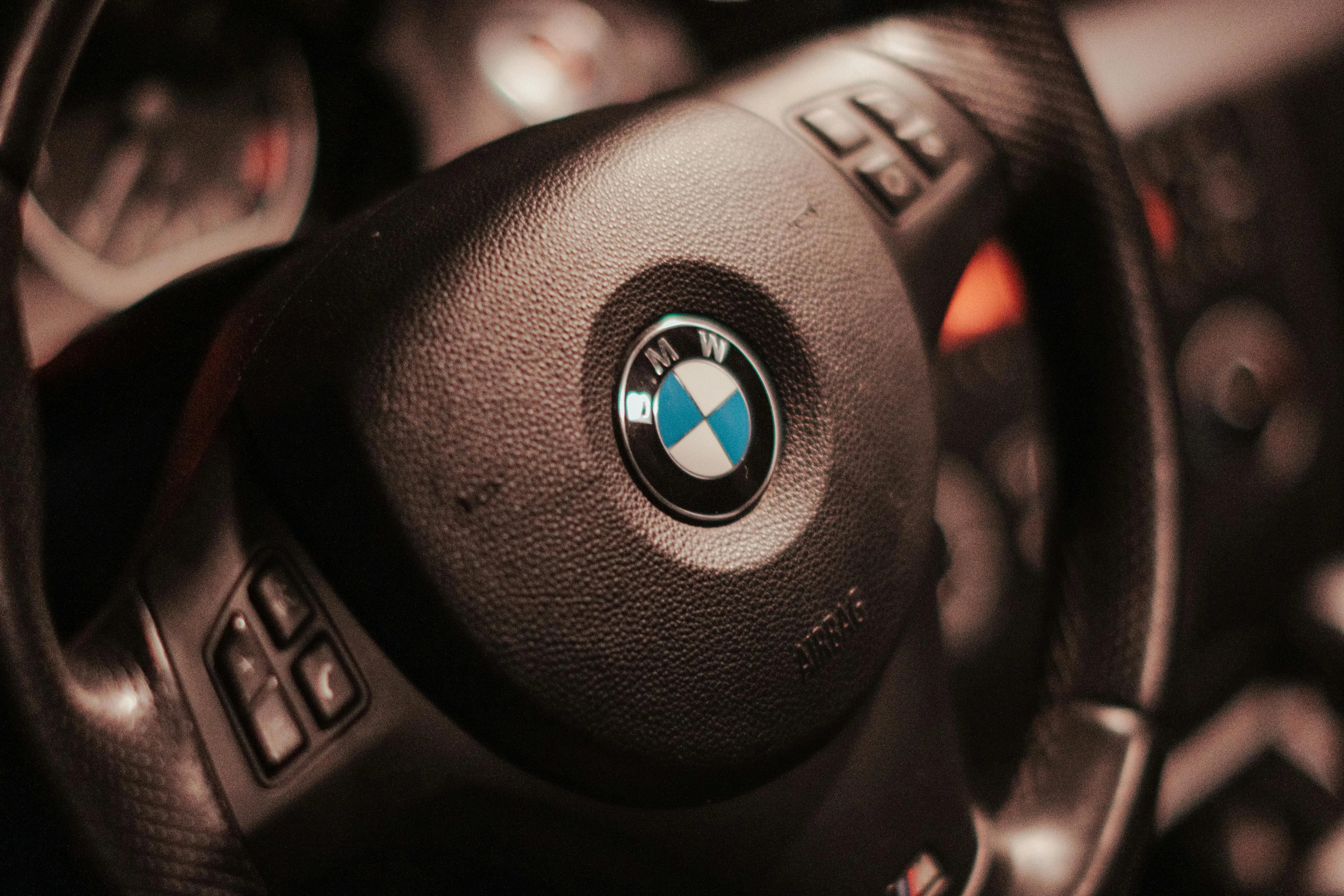 Close Up of Bmw Steering Wheel Inside a Luxury Car Cabin