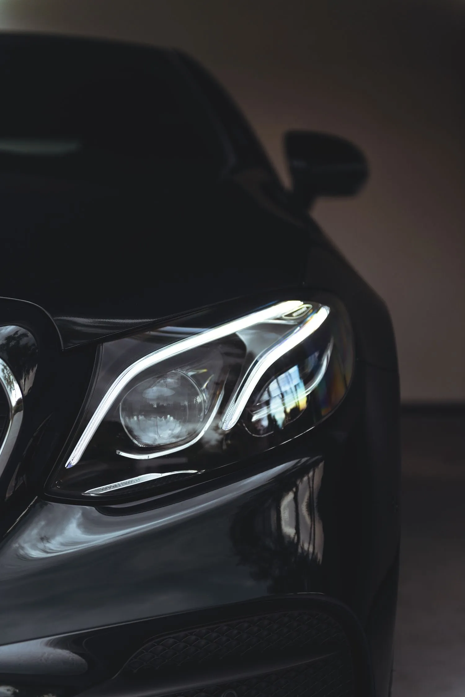 Close Up of Mercedes Benz Headlights in Dim Light Wallpaper
