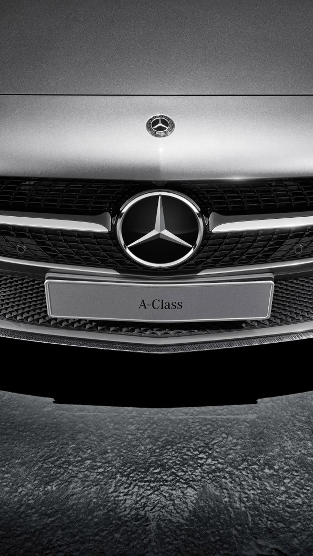 Close up of Mercedes Benz logo on a black and white car