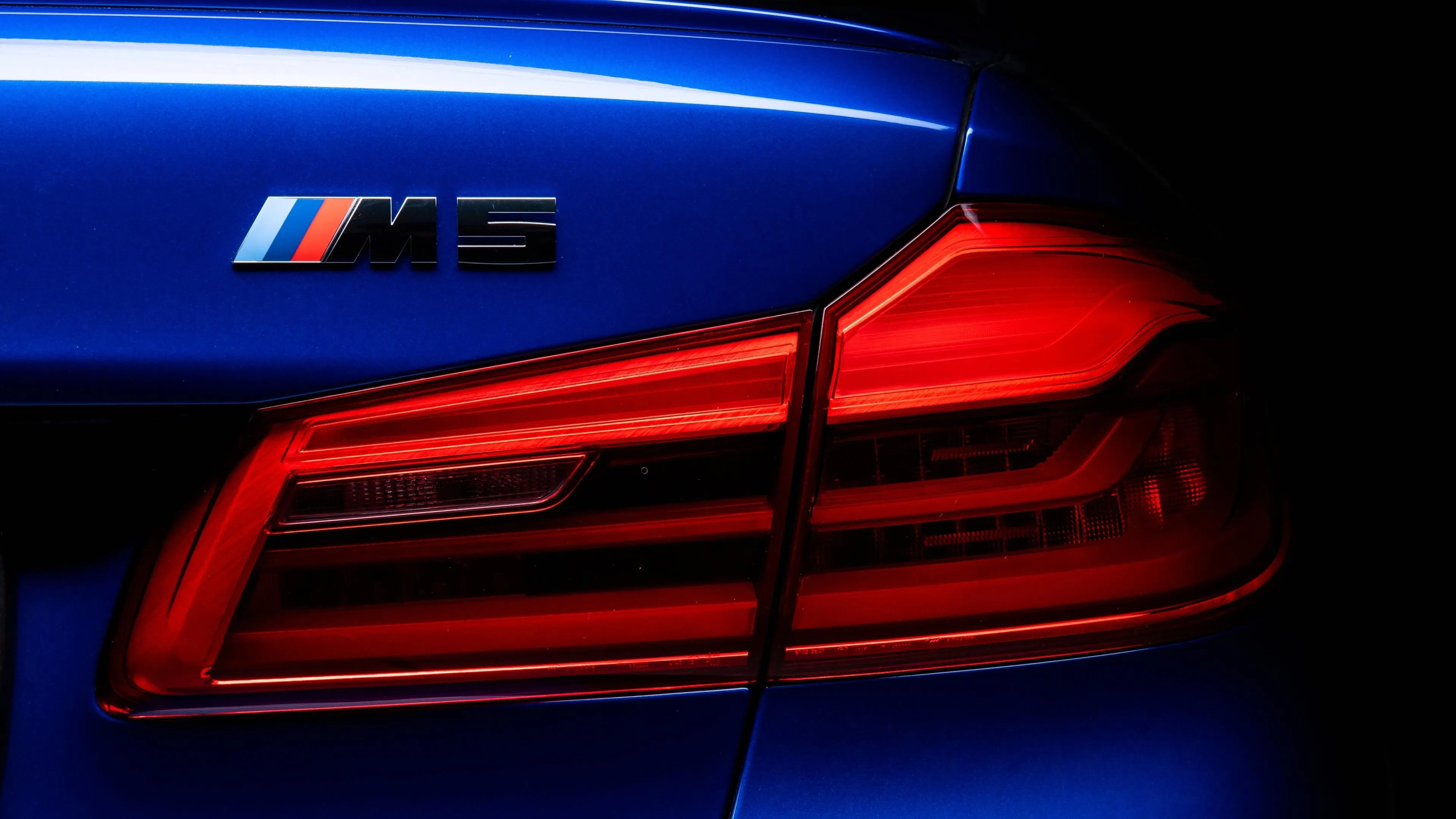 Close Up of Rear M5 Badge and Tail Light Glowing Red