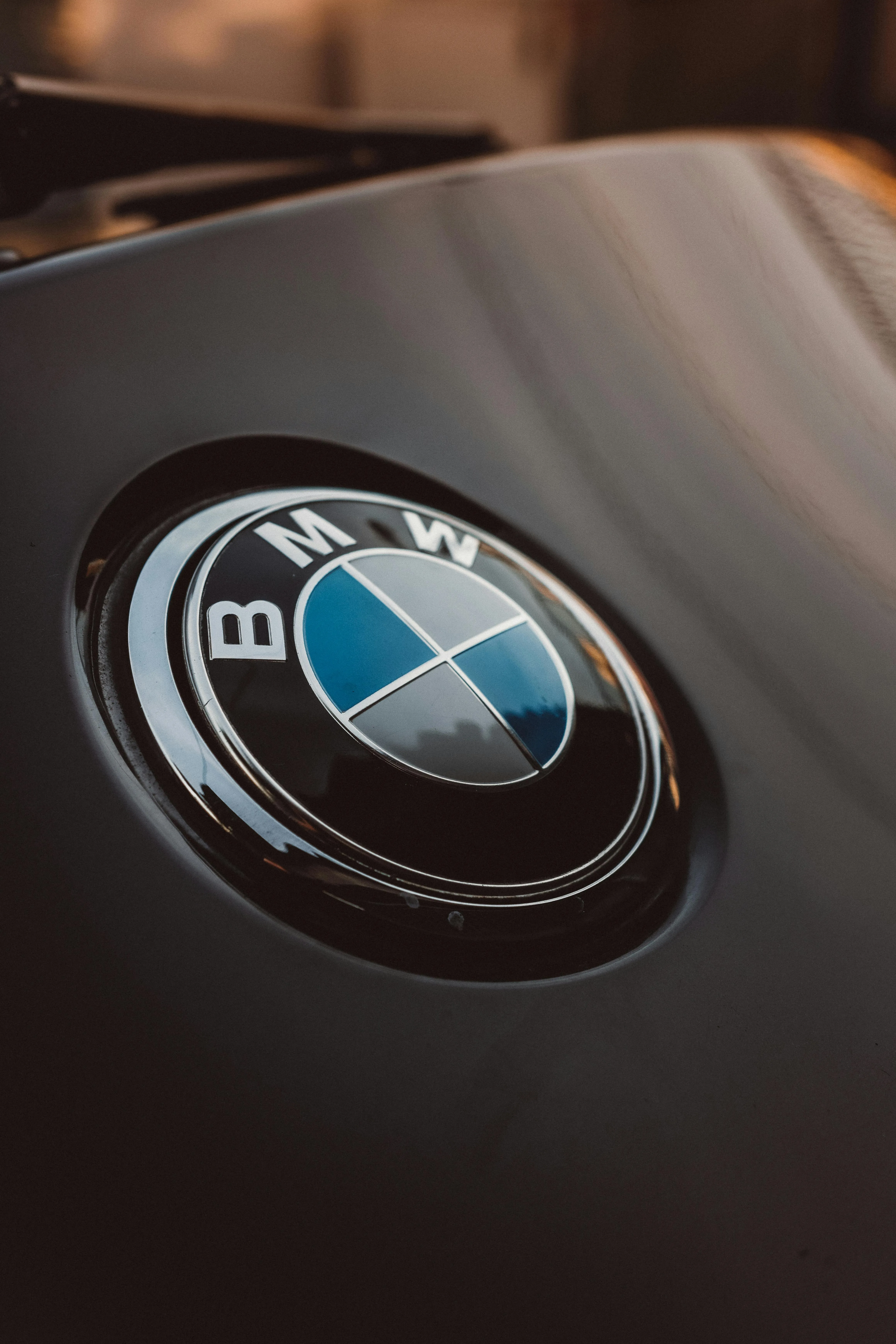 Closeup of Bmw Logo on Black Car Hood with Reflection