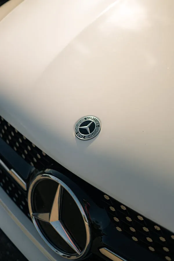 Closeup of Classic White Mercedes Benz Hood Ornament and Grill