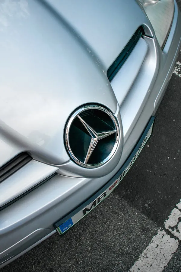 Closeup of Mercedes Benz Emblem on a Silver Car Hood